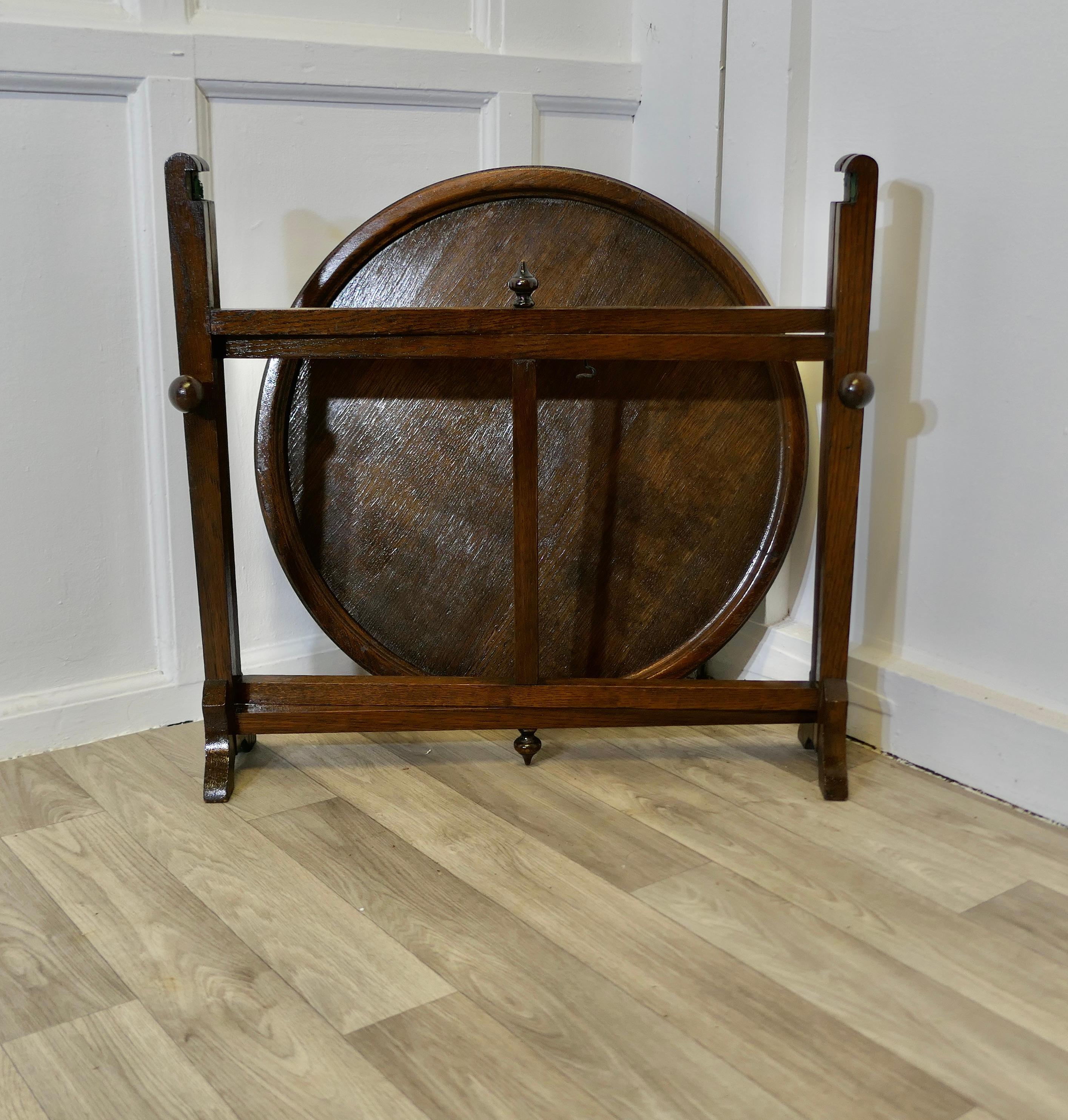 Revertable Oak Coaching, Campaign 0r Butlers Table 

A very clever design and a good quality sturdy piece, the table legs fold out to make a perfect square, and they have a top slot which holds the circular table top in place
When set up the table