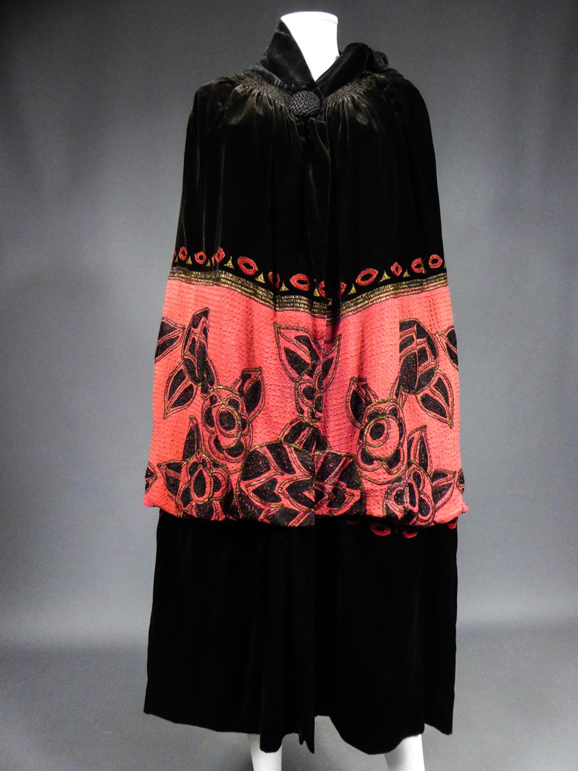 Circa 1920/1925
France

Long evening cape in black silk velvet and Fuschia cotton embroidered by the famous designer house Revillon Frère and dating from the Art Deco period. It is one of the oldest French designer houses founded in 1839 and known