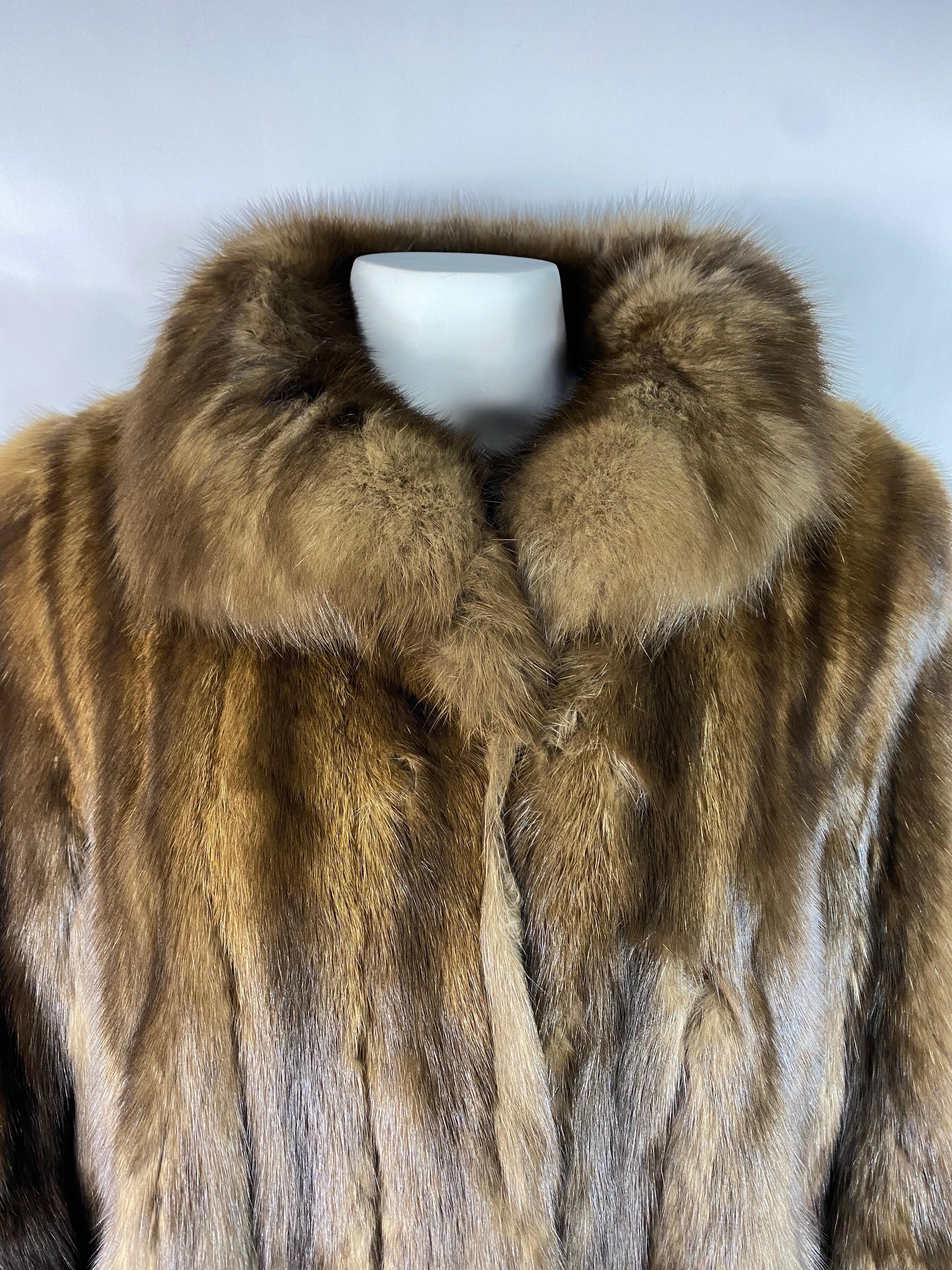 Product details:

Featuring 100% sable fur with double silk lining with collar and size pockets detail. Front double hook closure with inner belt. Mid length. Customized with embroidered first and last name of the owner Nadine Krakov on the inside.