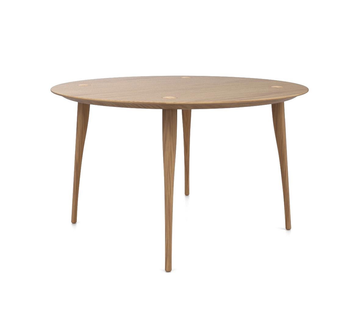 Dining at a Lewes dining table is one of the pleasures in life. We sit down with a glass of wine at a gently curved solid wood table. The wooden frame underneath the surface has 4 organic shaped legs which protrude elegantly through the surface of