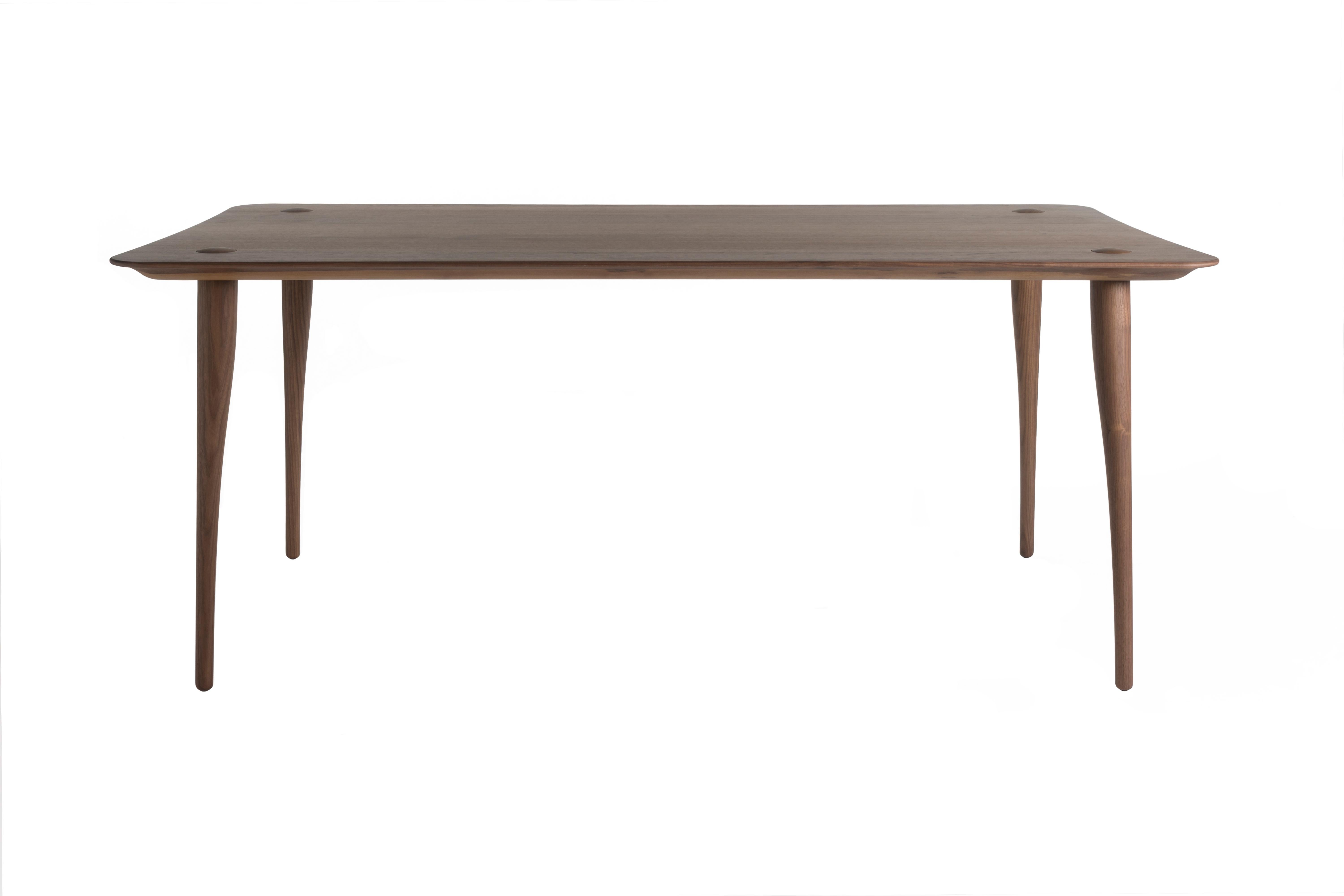 Dining at a Lewes dining table is one of the pleasures in life. We sit down with a glass of wine at a gently curved solid wood table. The wooden frame underneath the surface has 4 organic shaped legs which protrude elegantly through the surface of