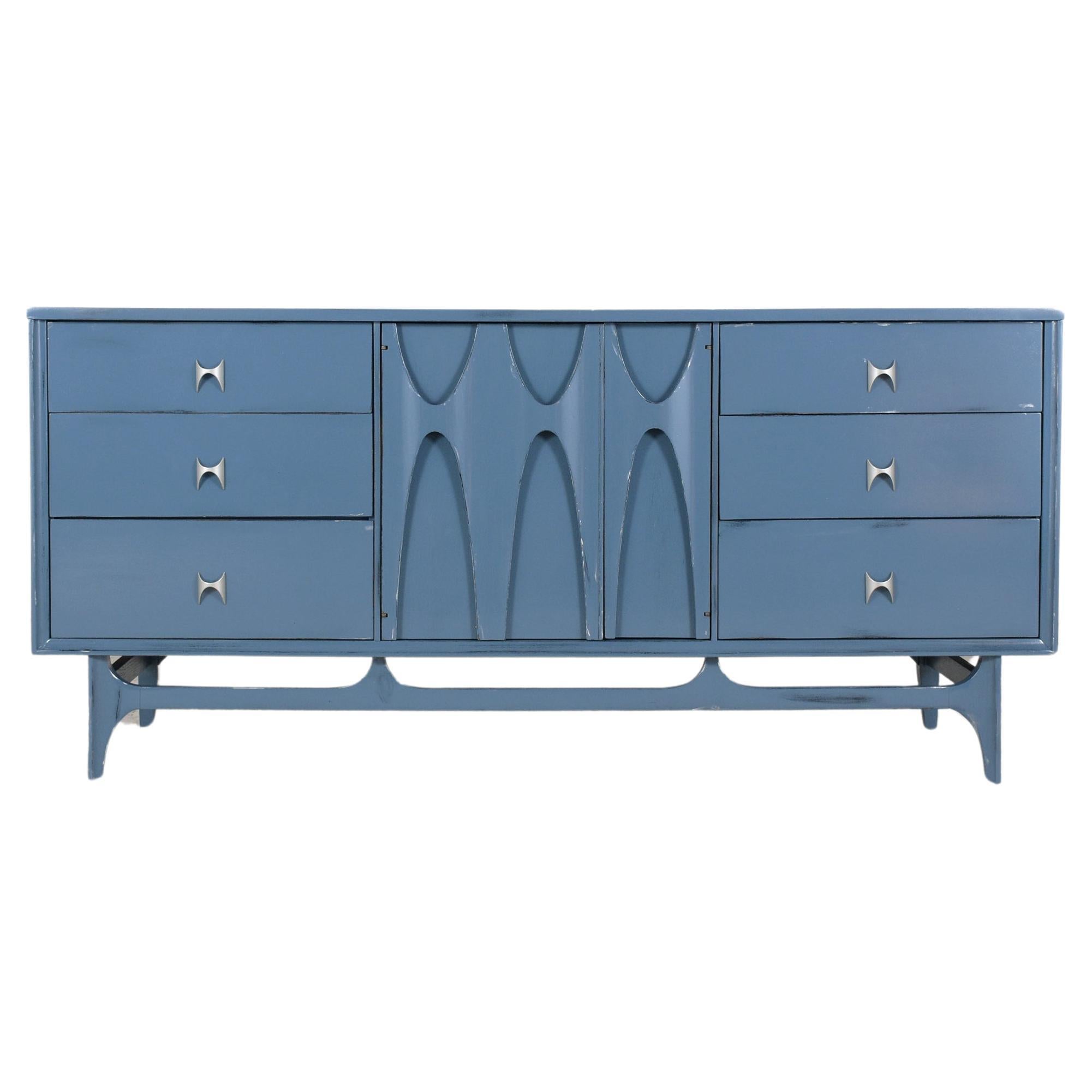 Rediscover the 1960s elegance with our beautifully restored Broyhill Brasilia credenza, a shining example of mid-century modern design's enduring allure. Skilled artisans have meticulously revitalized this piece, now boasting a vibrant custom blue