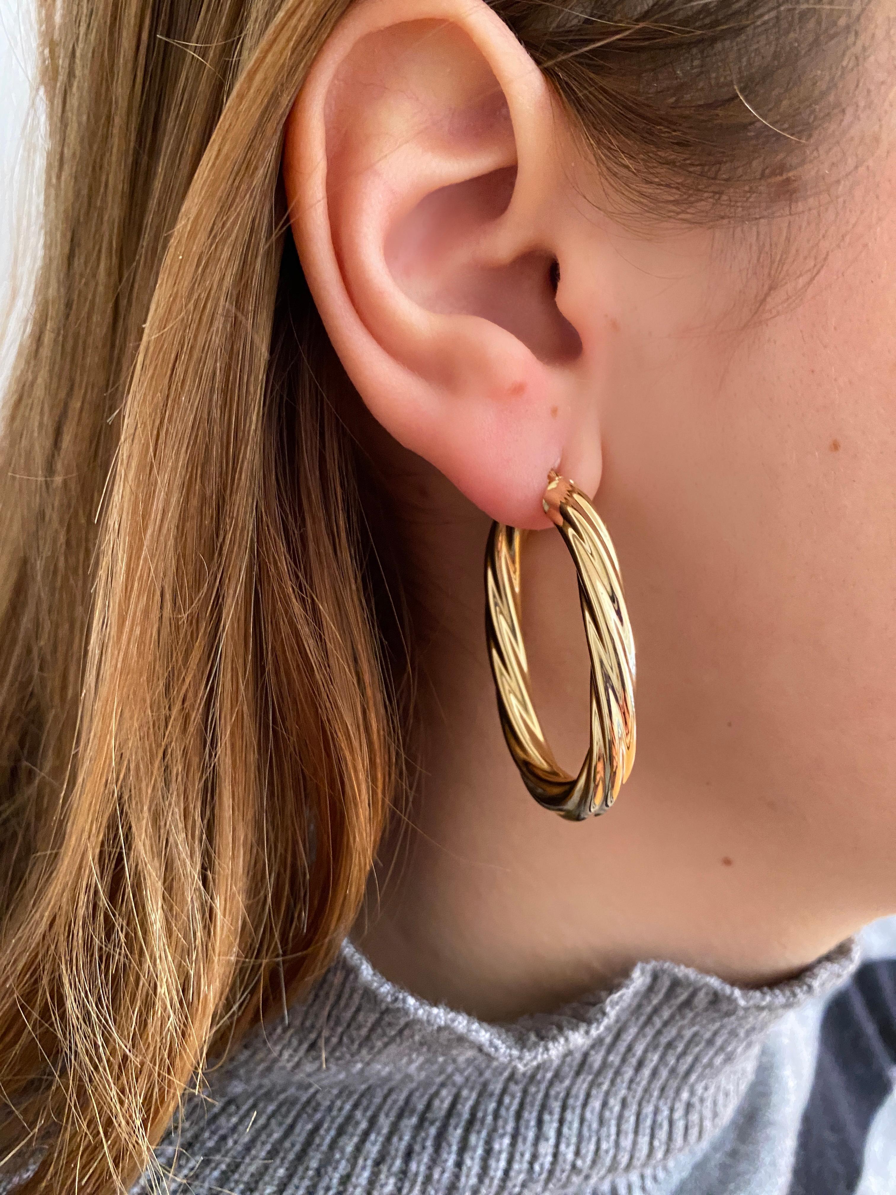 Revival Earrings from the 90th Century, a timeless treasure crafted in 18K yellow gold. 
These oval hoop earrings boast impeccable condition, showcasing no marks or dents, ensuring lasting beauty and durability.

The oval shape of these earrings