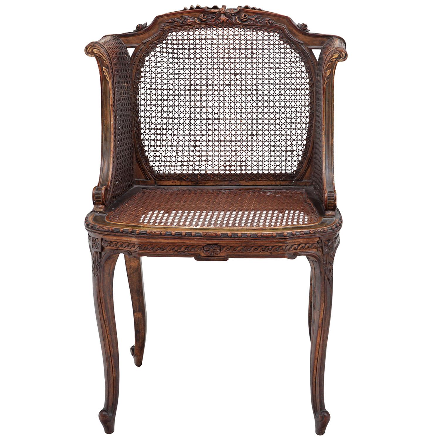 Armchair standing on slightly s-shaped legs with wickerwork seats and backrests. The frames are adorned with a band of carvings which are mostly roses. The high sides end with rocaille ornaments.