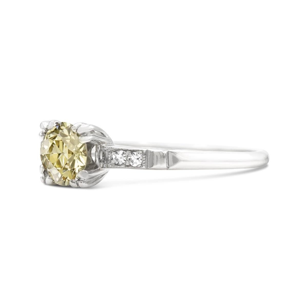 A sunny diamond in an original art deco setting, this ring has all the makings of a unique engagement ring. Centered by a fancy yellow 1.21 carat old European cut, the diamond has the old-world proportions that make antique diamonds so attractive.