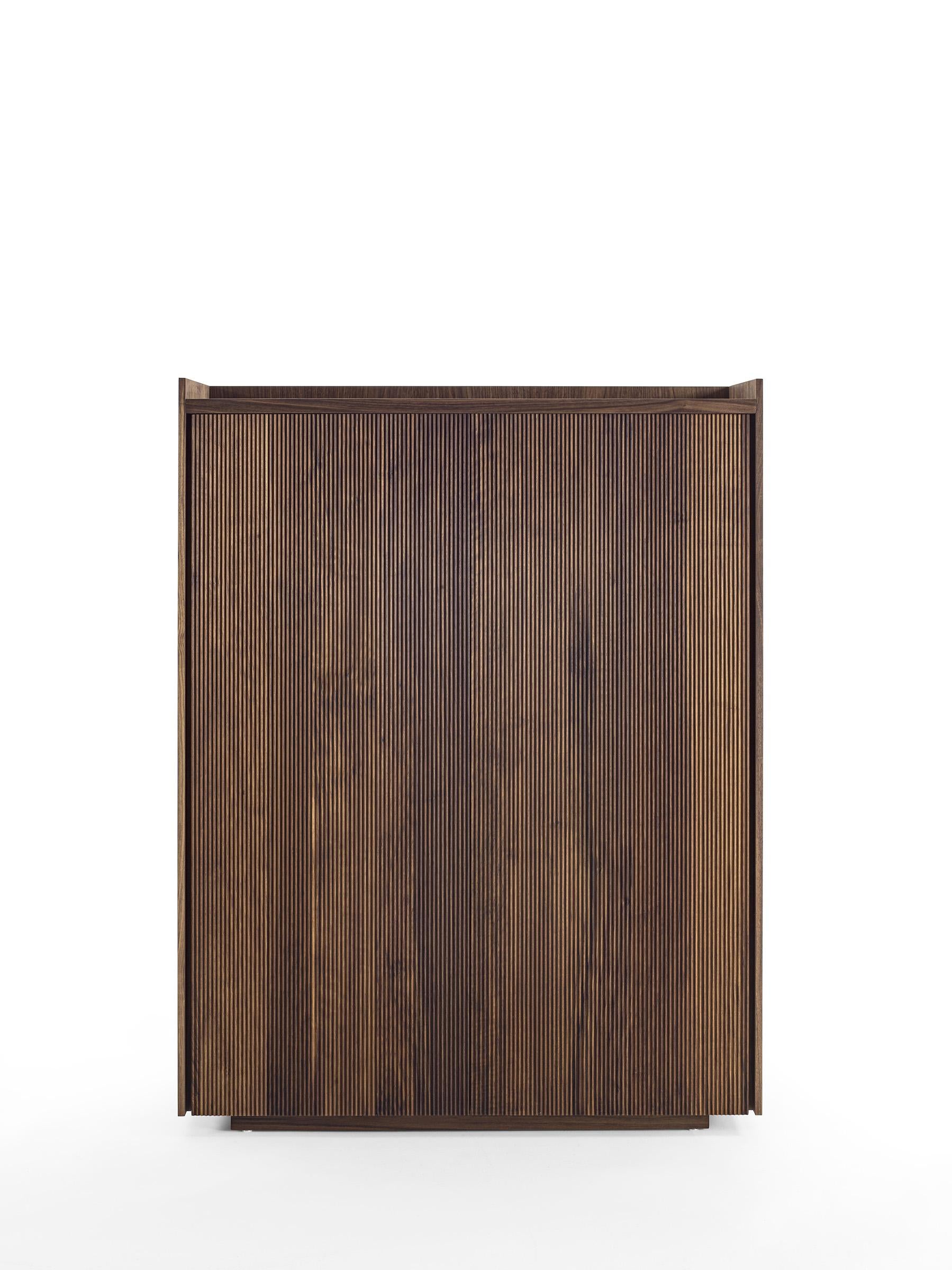 Highboard aus Massivholz und Tischlerplatte, gekennzeichnet durch einen Rahmen, der die Platte, die Innenböden und die Schubladen enthält, die mit traditionellen Schwalbenschwanzverbindungen und einem gerillten Griff gefertigt sind. Ausgestattet mit