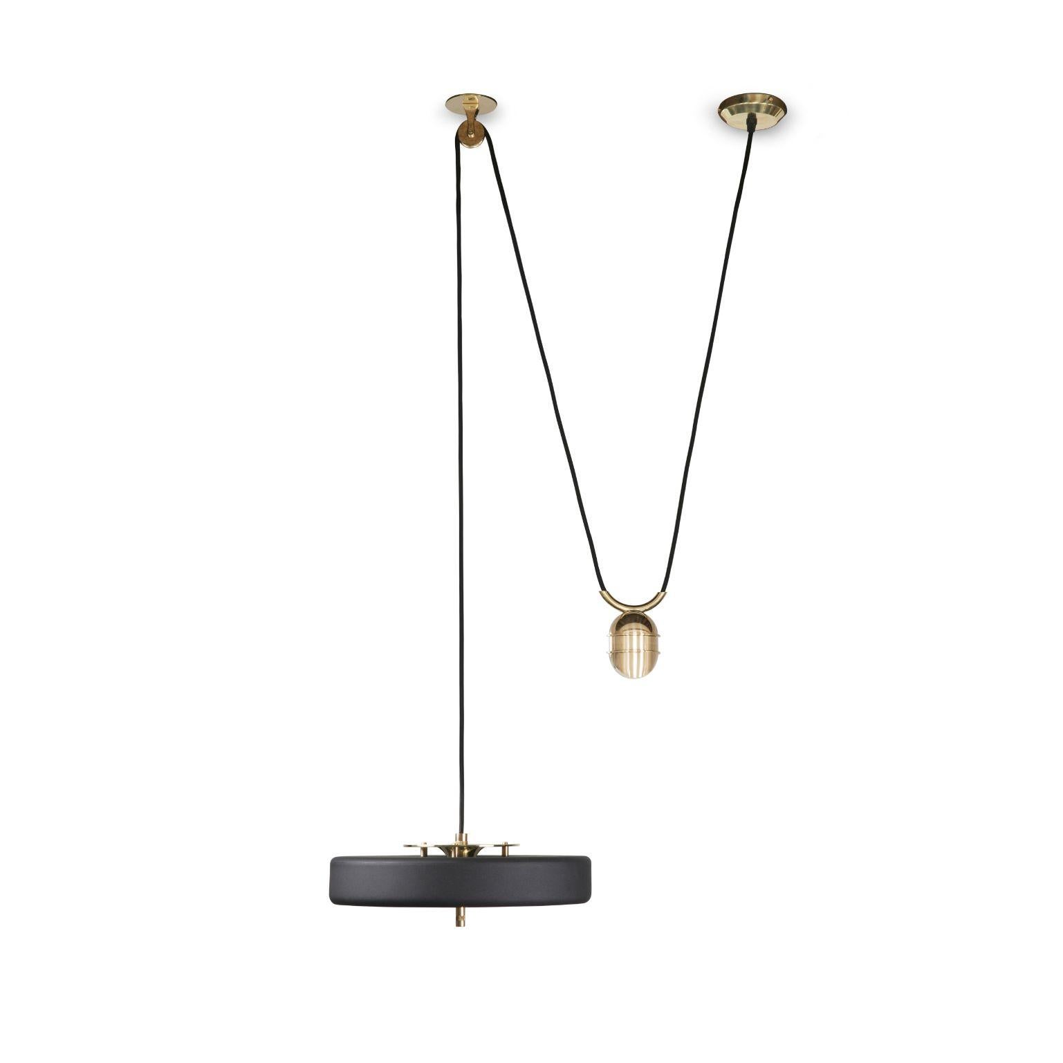 Revolve rise and fall pendant light - Brushed brass - Black by Bert Frank
Dimensions: 30 x 35 x 11 cm, small lamp: 7.6 cm
Materials: Brass, steel

Also available in polished brass
When Adam Yeats and Robbie Llewellyn founded Bert Frank in 2013