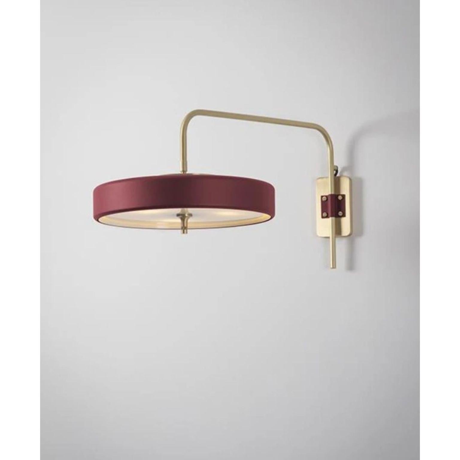 Revolve wall light - Brushed brass - Oxblood by Bert Frank
Dimensions: 31 x 63 x 35 cm
Materials: Brass, steel

Available in polished brass

Flush-fitting opal glass shade with central dome of polished marble – white Carrara or green Guatemala
