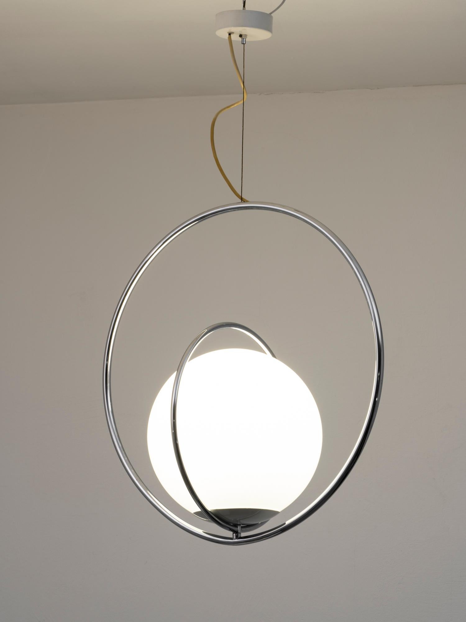 Magnifique lampe suspendue de la designer italienne Pia Guidetti Crippa pour Lumi, datant du début des années 1970. Cette lampe est composée de deux anneaux tournants en métal chromé, qui peuvent créer différentes formes, et d'un verre opale. Il est