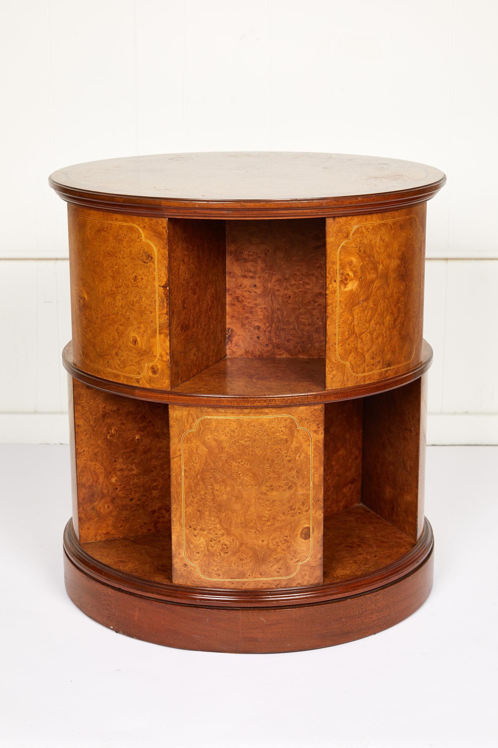 Early 20th century English round rotating library cabinet or side table made of bird's-eye maple and mahogany with satinwood and ebony decorative string inlay.