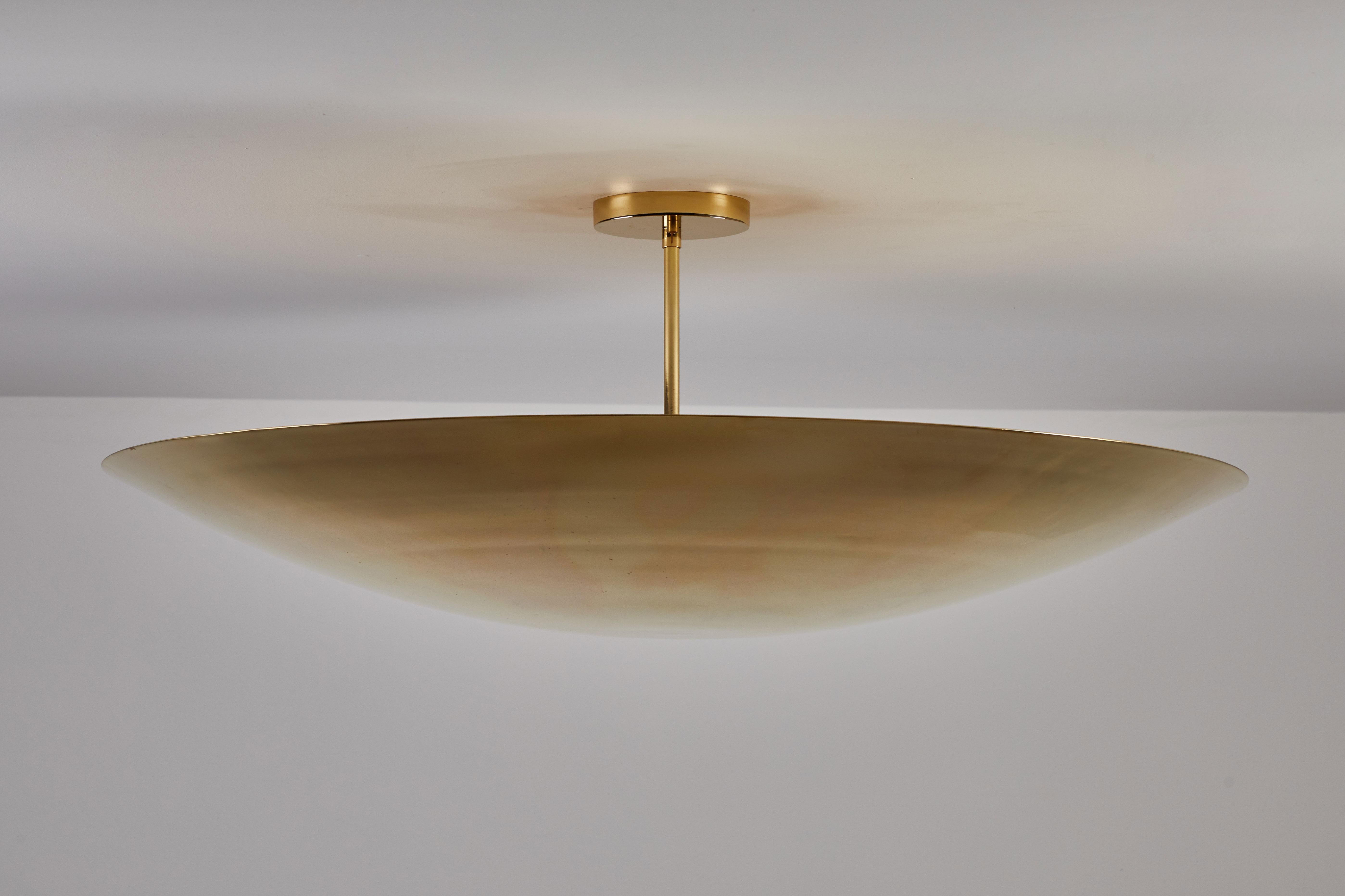 Rewire custom ceiling light. Designed and manufactured in Los Angeles by Rewire. Large un-lacquered brass dish with four internal sockets. Takes four E26 60w maximum bulbs. Brass hardware and canopy.
Brass Plated Steel.
