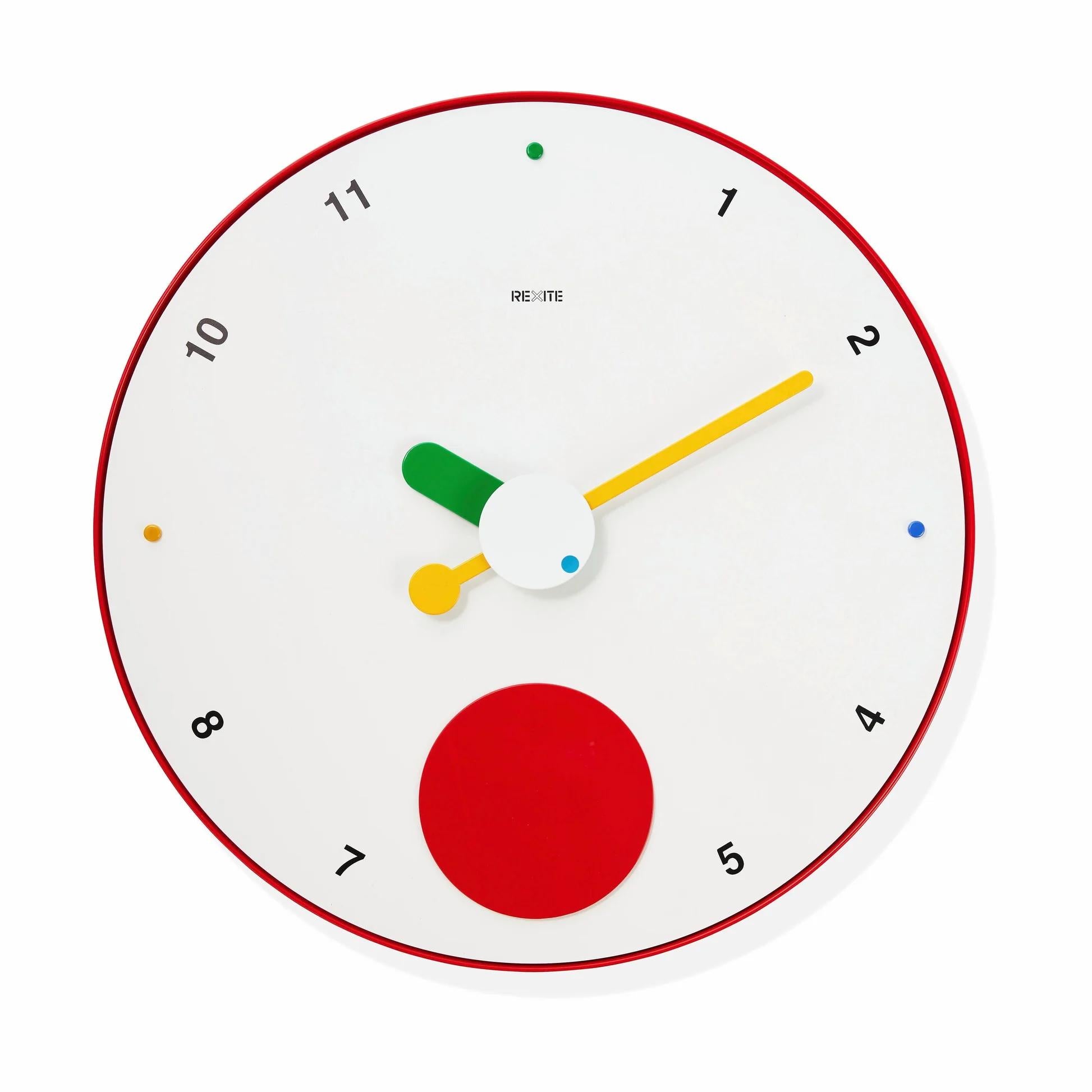 The Contrattempo – Bianco wall clock by Rexite turns the everyday rhythm into a playful and uplifting experience. The large red disc swings continuously, magically suspended over a white dial, softening the impact of daily surprises and infusing the