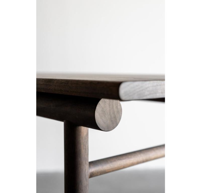 The Reyes Console is handmade locally in Los Angeles, California. The console is crafted from solid walnut with a rich, dark stain. A wrapped structural leather shelf provides a natural and beautiful surface that remains striking, even when left