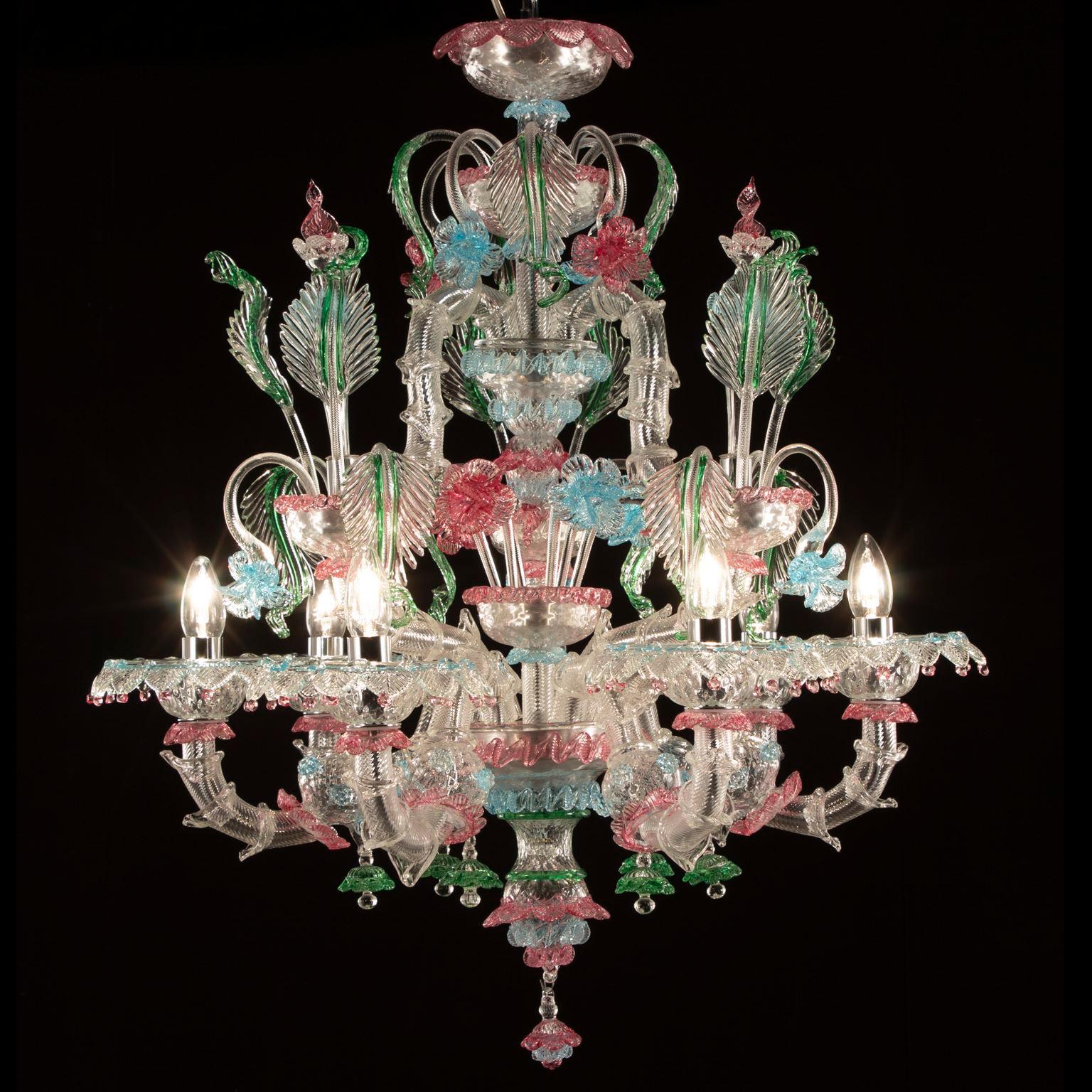 This rezzonico chandelier 6 lights in clear Murano glass with colorful details by Multiforme is completely handmade.
It is the combination of the traditional Venetian structure with gaudy colors. A peculiar lighting works, lively and exuberant: we