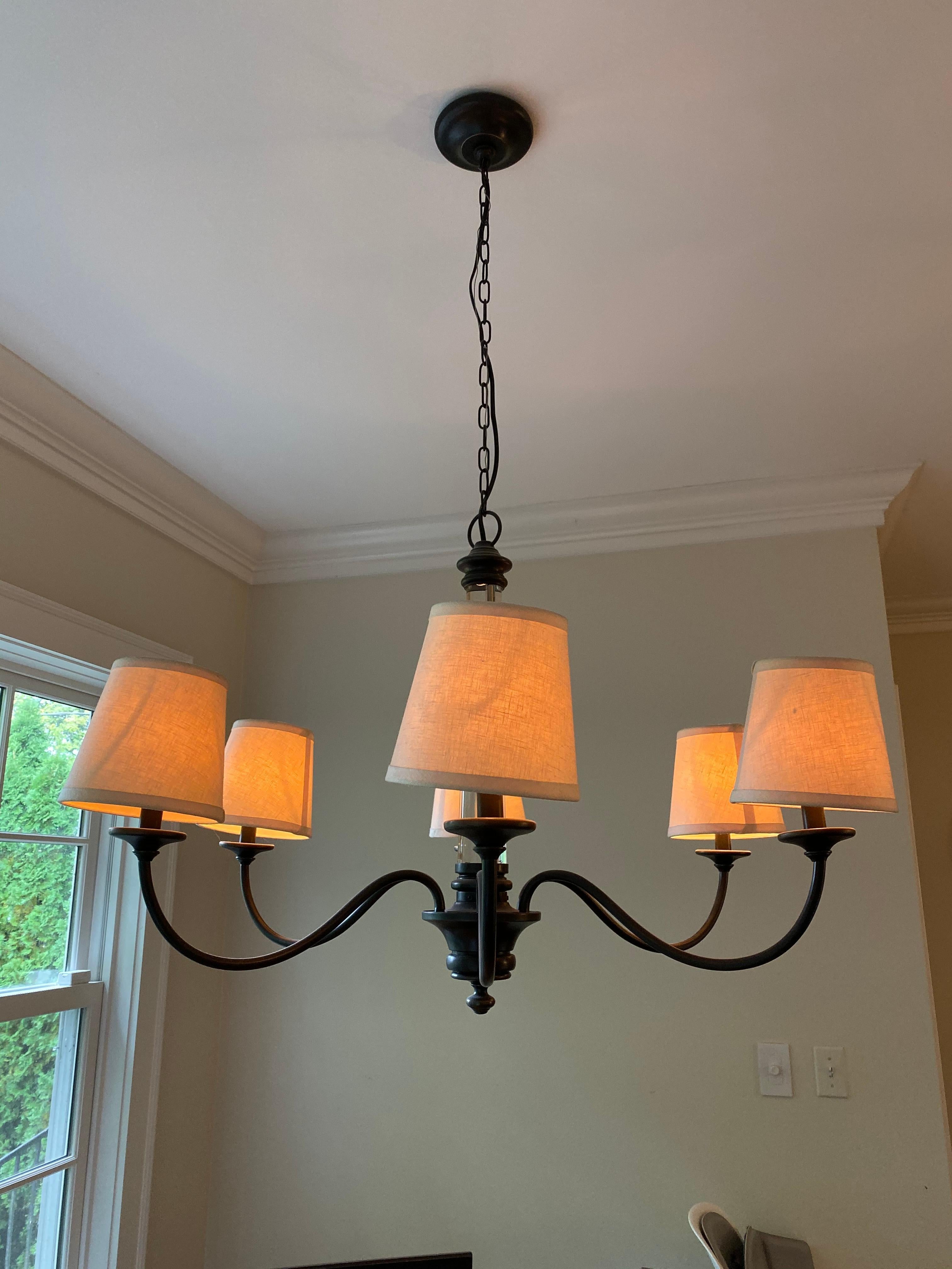 Graceful arms, clear iconic column, forged iron finish, natural linen shades
this farmhouse or rustic 6-arm chandelier will look perfect over your kitchen or dining table,
just in time for the holidays!