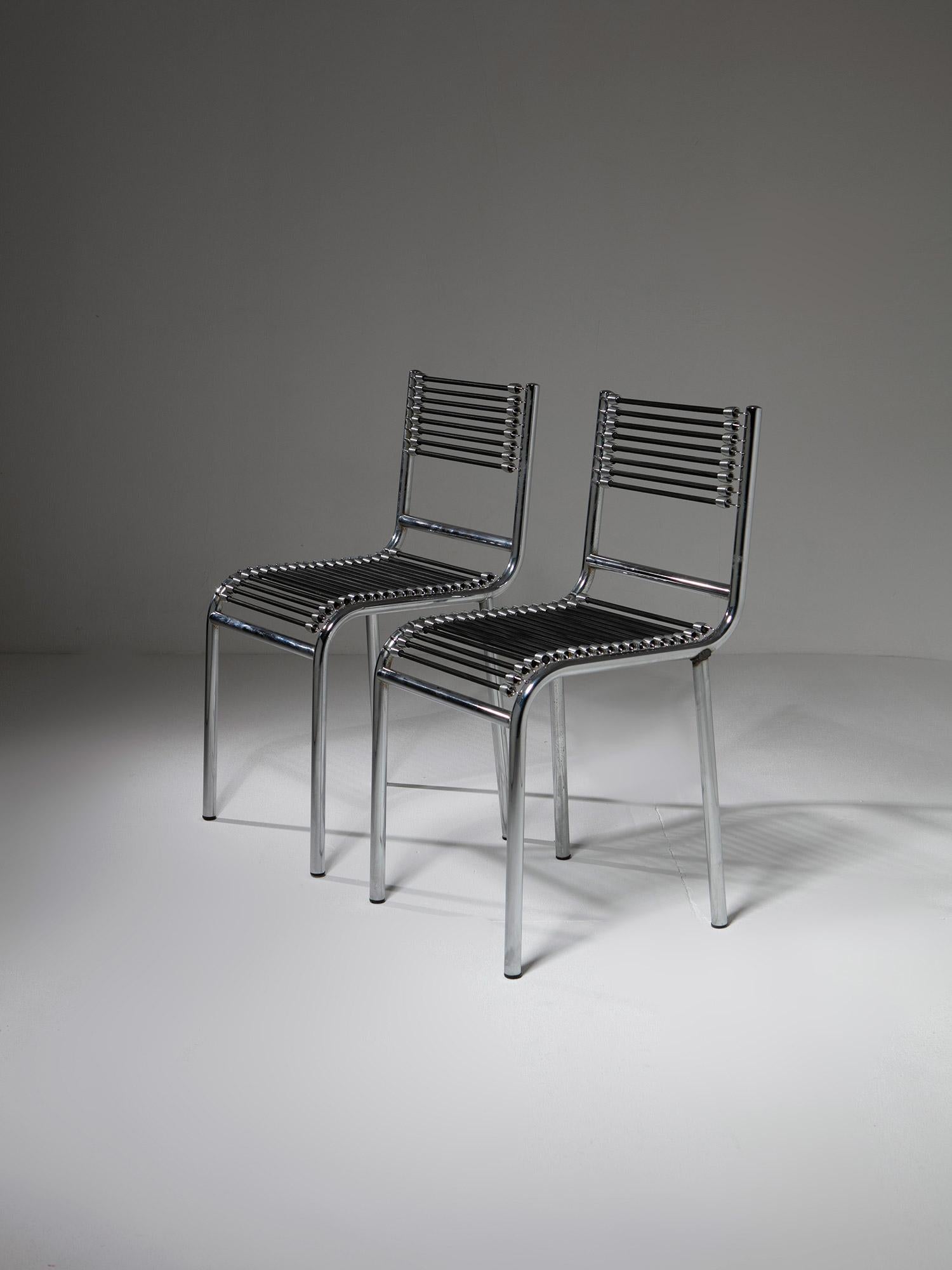 Pair of R.H. N°1 chairs by Renè Herbst.
1928 project issued in 1980 by Pallucco featuring tubular steel chrome plated frame.
Back and seat rest are composed by black tension straps with chromed clamps clamping the structure.
