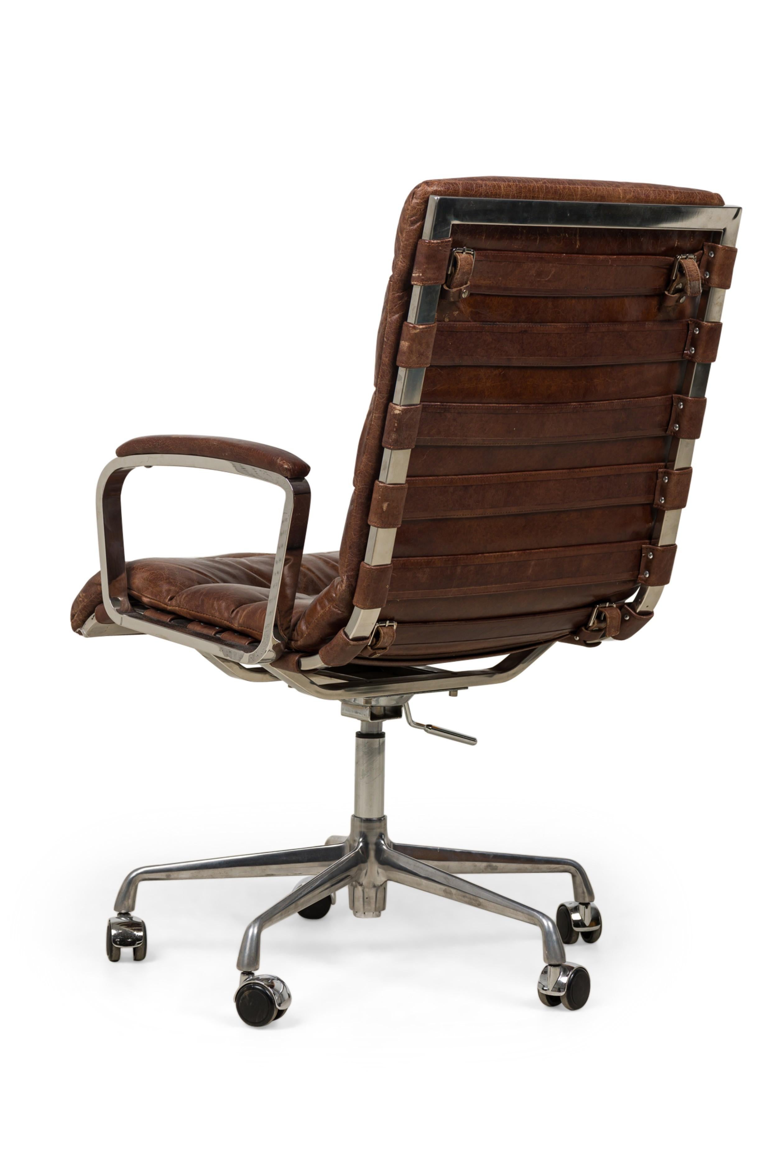 Mid-Century American-Style tufted brown leather upholostered swivel / desk chair in channeled brown leather upholstery with a cantilevered chrome frame featuring height adjustment and belted leather support straps, resting on a starburst base with 5