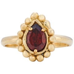 Rhea Ring with Garnet, 18 Karat Yellow Gold