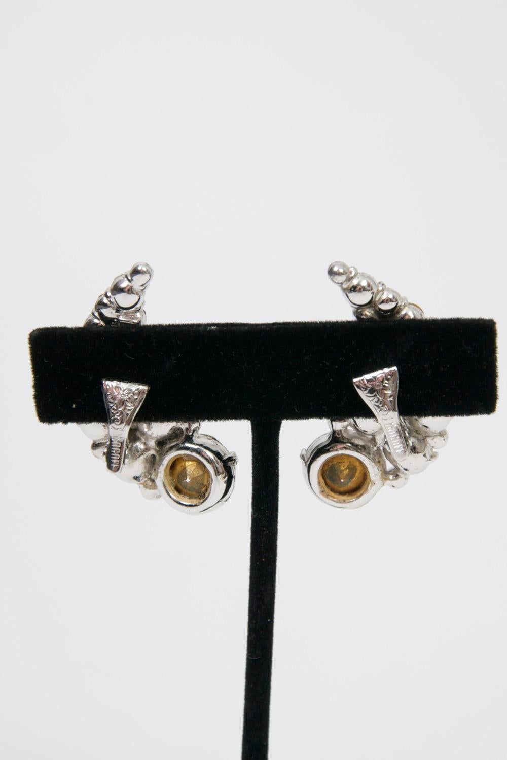 Known for their high quality costume jewelry, Jewels by Bogoff, located in Chicago, was a leading manufacturer of rhinestone jewelry from 1940 thru the early 1960s. This pair of clip-on earrings features round rhinestones of various sizes arranged