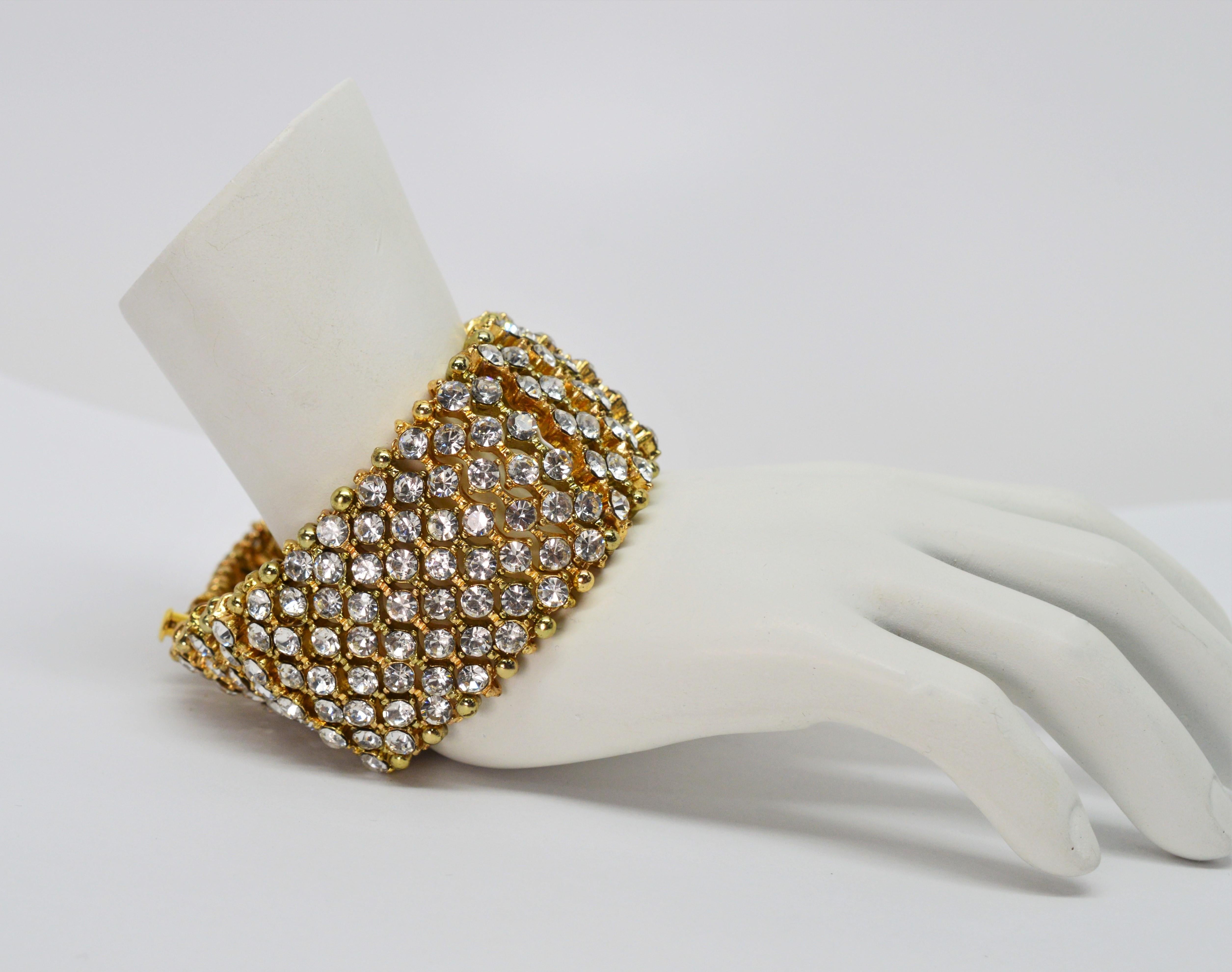 Brilliant rhinestone crystals cause a sensation when wearing this unusual costume jeweled bracelet. Restored and strung on gold plated chain to create this bracelet are striking 1-1/4 inch wide dazzling crystal laden links set in a gold-toned base