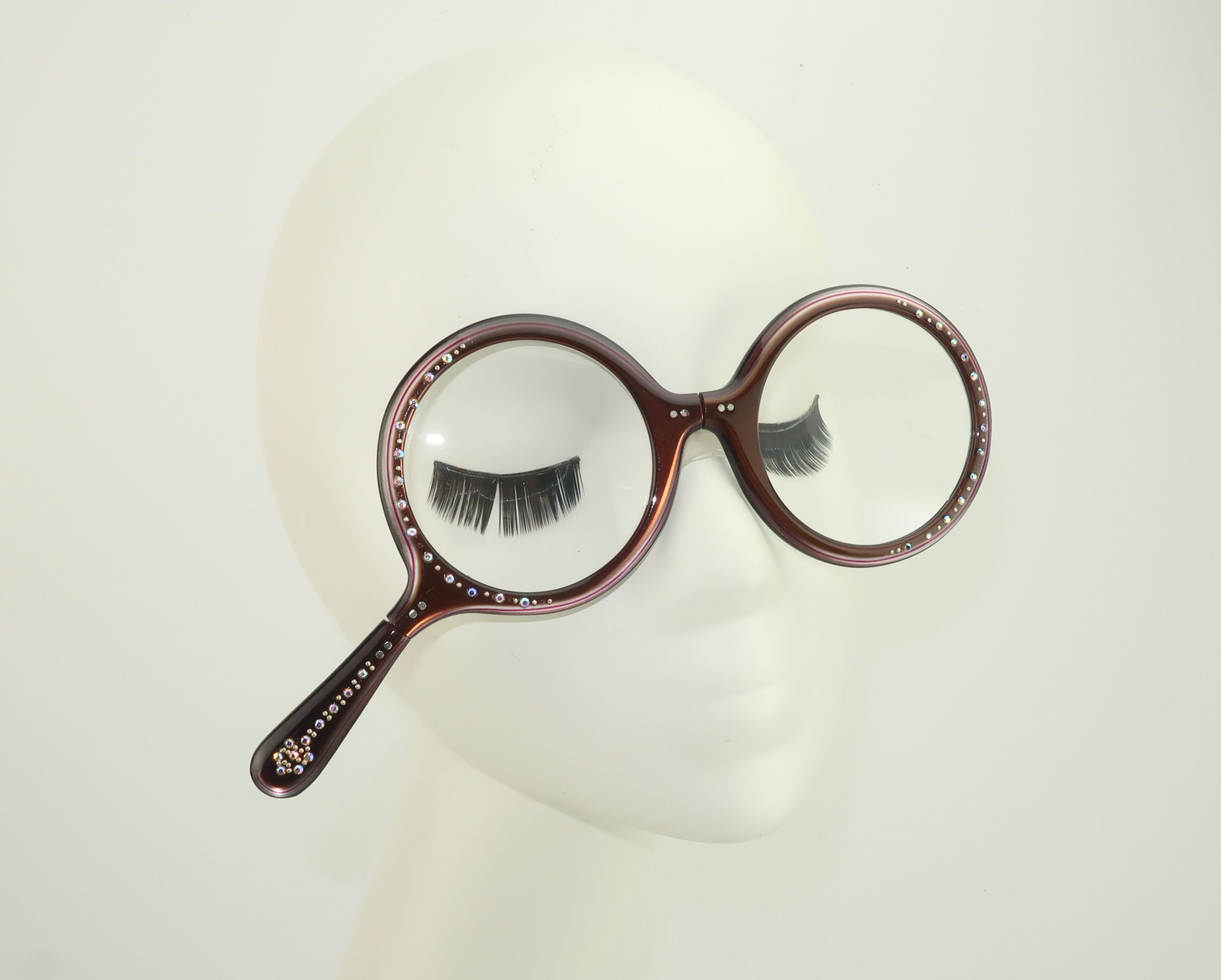 Vintage milk chocolate brown foldable lorgnette reader or magnifying glasses with rhinestone accents and an exaggerated round look.  There is a subtle red stripe running the circumference of the lens that gives the frame the hint of a light purple