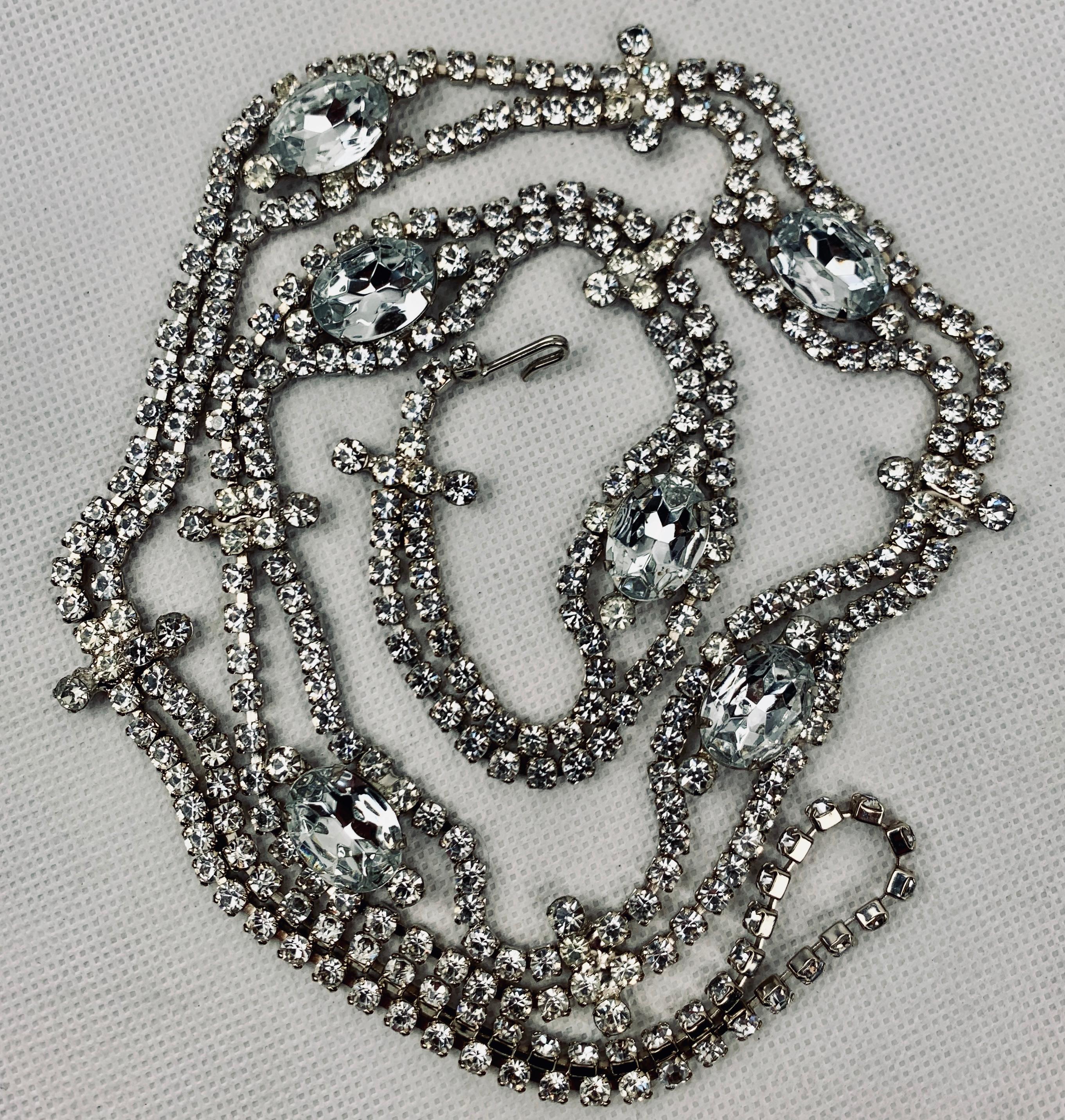 Eye catching 1960's rhinestone belt that would look great as a necklace.  There are six large oval stones connected between a double strand of round stones.  All of the stones are prong set.  At the end of this piece there is a hook for connecting