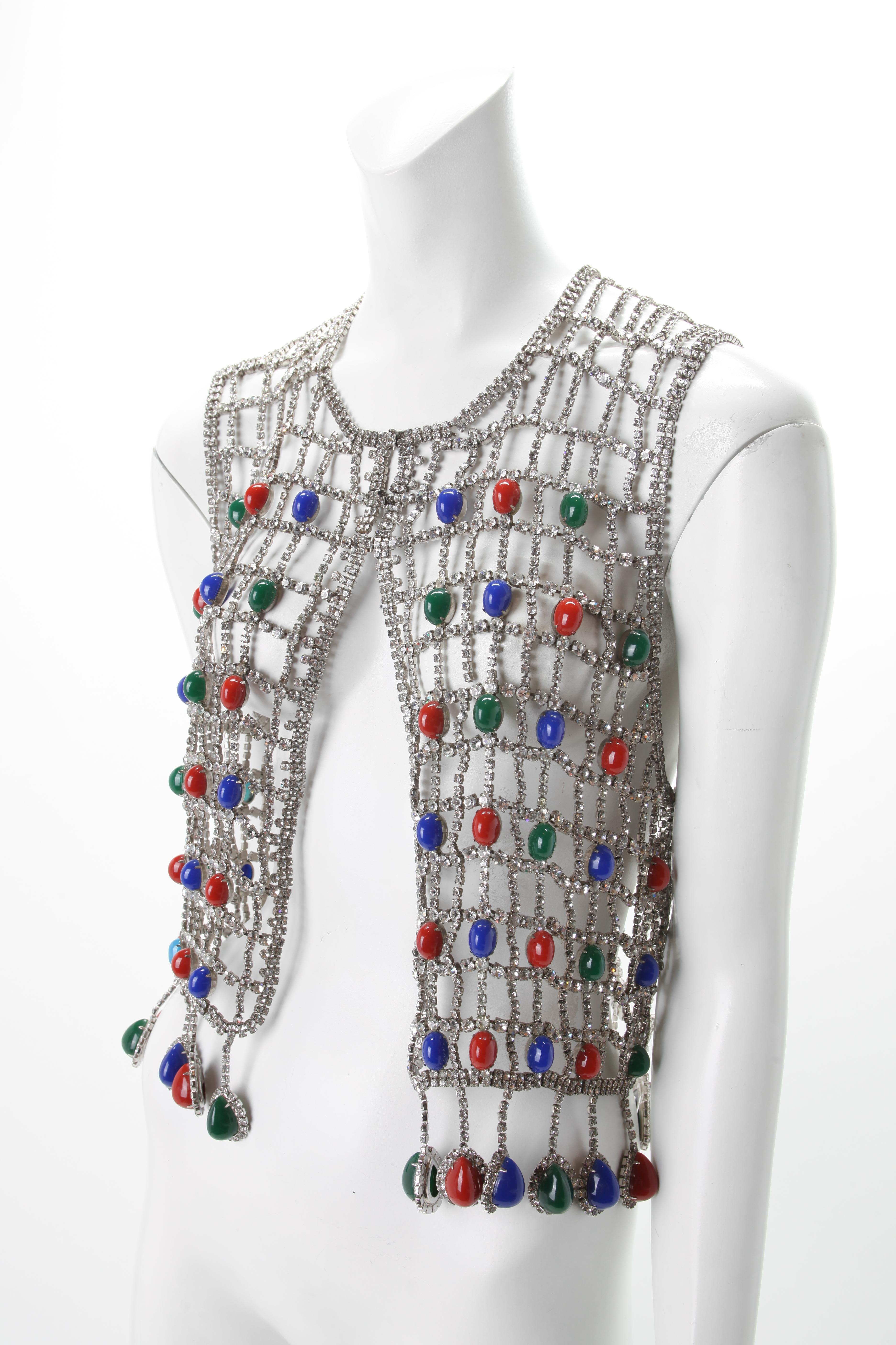 Rhinestone Vest with Multi Colored cabochon Beads, c.1970s
Spiderweb Rhinestone vest with large blue, green and red beads throughout. Features Rhinestone and large bead tassels along the waistline. 

Fits US Size 0 to 4