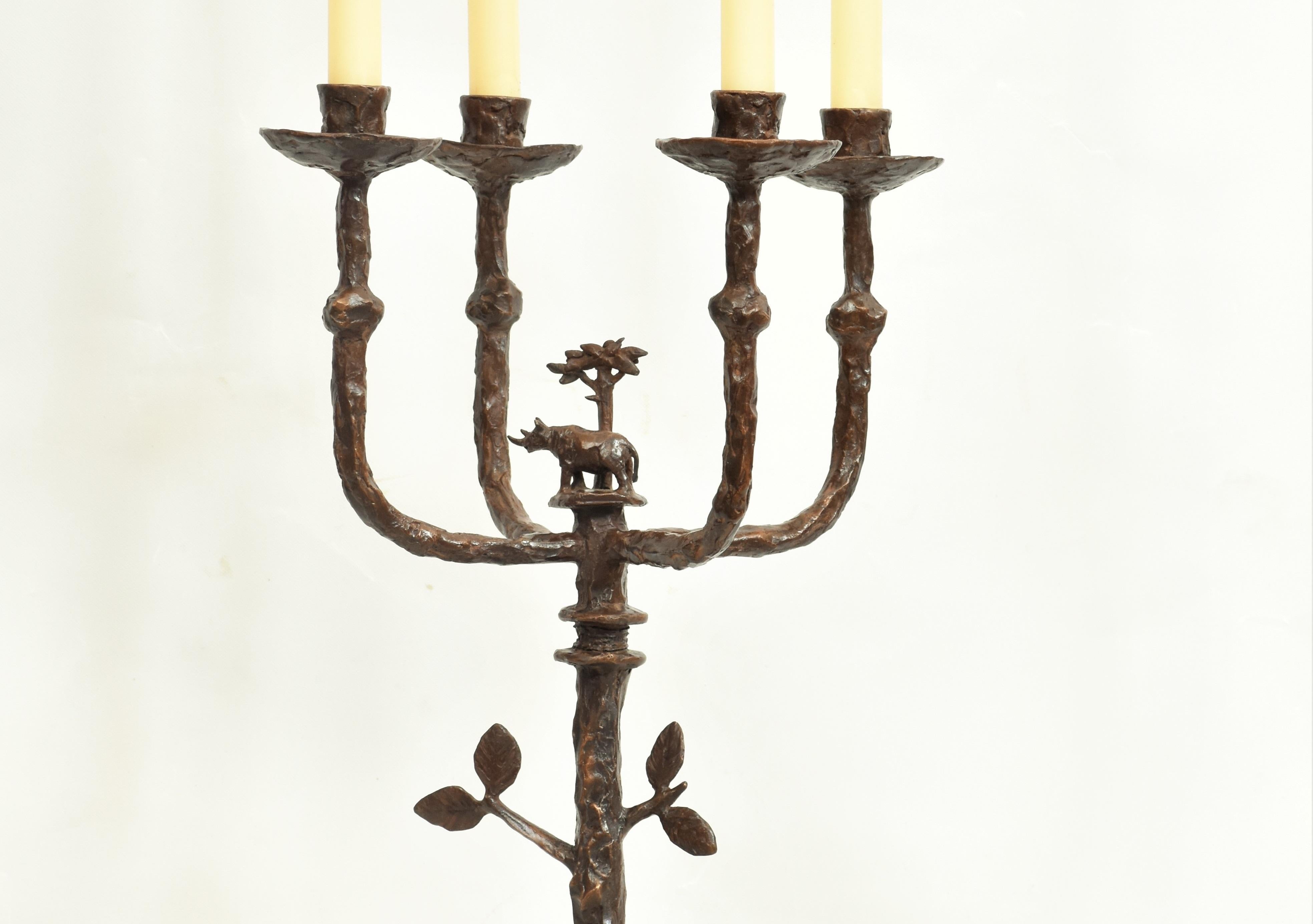 Rhino Candelabra, Height 47 cm x Width 26 cm, Candlestick in cast bronze with brown patina with small Rhino, Acacia tree and leaf motif. Candles not provided. Similar bronze single and double candle sticks in different sizes & motifs on request.