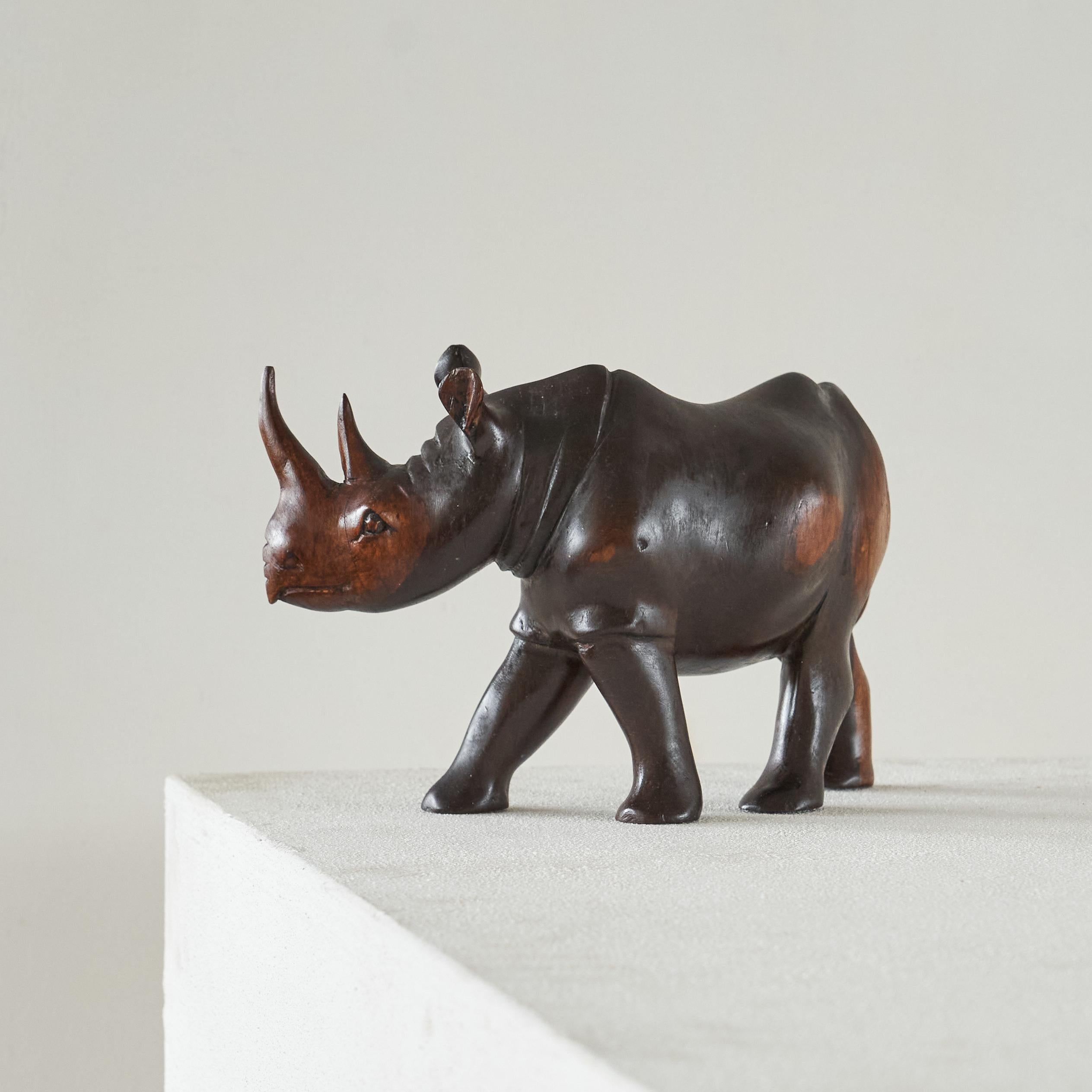 This is a wonderful rhino sculpture in solid carved wood, Europe, 1950s.

Very well made, this rhino sculpture features nice wood grain and colors - great shape and proportions. 

Great on a desk, cabinet or on your coffee table next to some books.