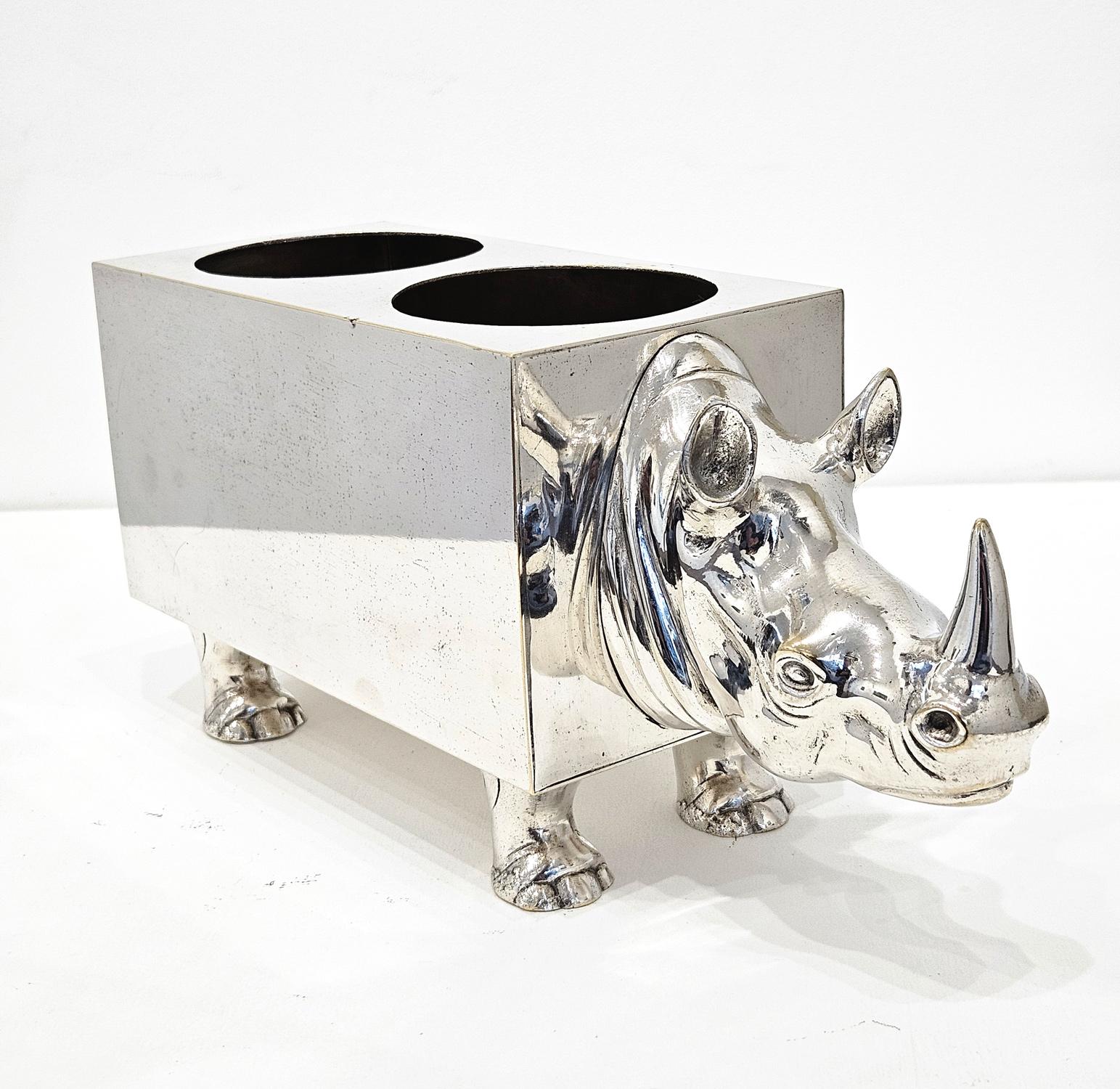 A mid 20th century silver plate double wine bottle holder in the shape of a rhinoceros, made in Spain c. 1960s. 

It is a most charming object, with the rhinoceros head, feet, and tail beautifully executed. The central body is rectangular in shape
