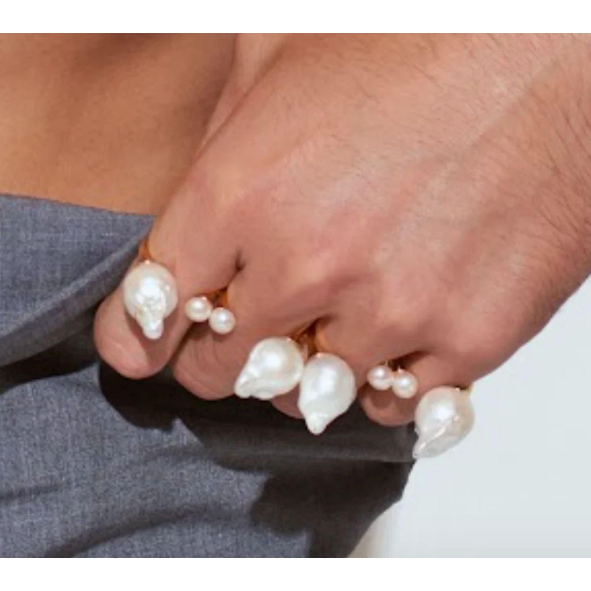 A luxurious twist on the armor knuckle rings. Baroque and freshwater pearls in an adjustable 4 Finger Ring. Match with our single ring for the thumb. Gold plated brass rings with freshwater and baroque pearls. Handmade in Los Angeles.

Additional