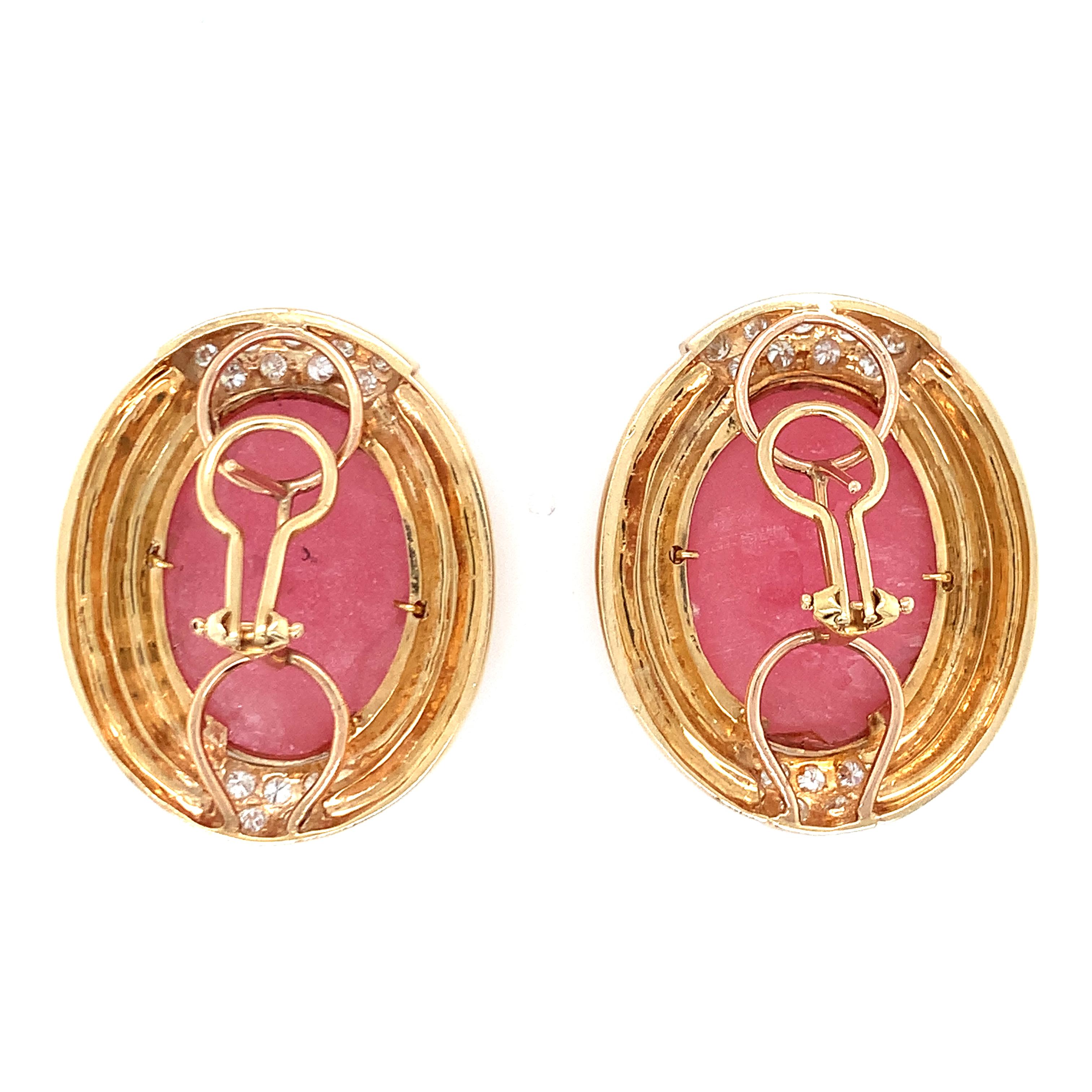 One pair of rhodochrosite and diamond 18k yellow gold earrings featuring 2 oval cabochon rhodochrosite totaling 40 ct. (20 ct. each measuring 23 x 16.5 millimeters) with 28 round brilliant cut diamonds totaling 1.25 ct. Enhanced by 14K yellow gold