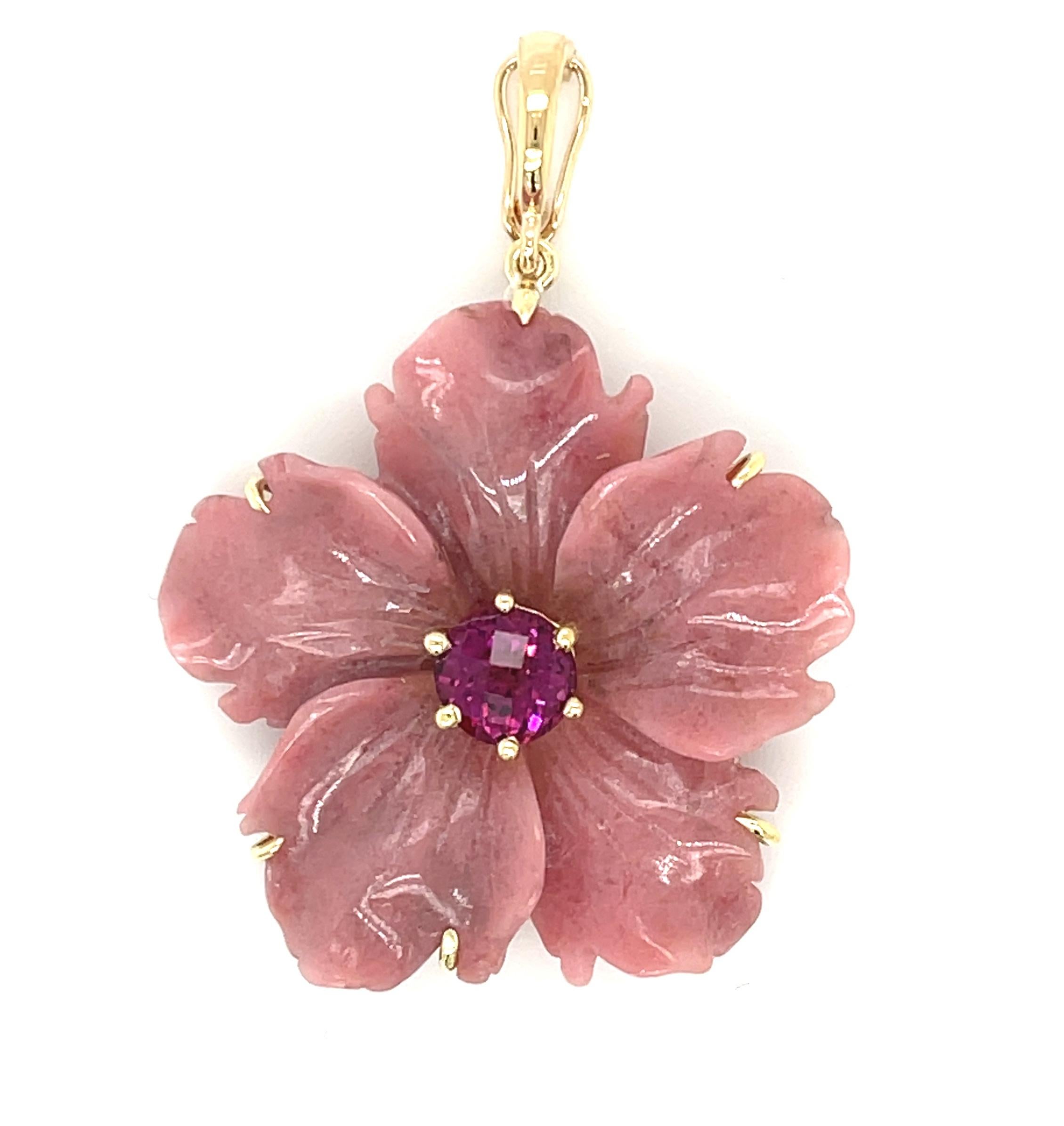 This eye-catching necklace features a beautifully hand-carved rhodonite floral pendant on a lovely strand of rose-colored rhodochrosite beads. The 6mm beads were hand strung on silk thread and accented with richly colored, round garnet beads that