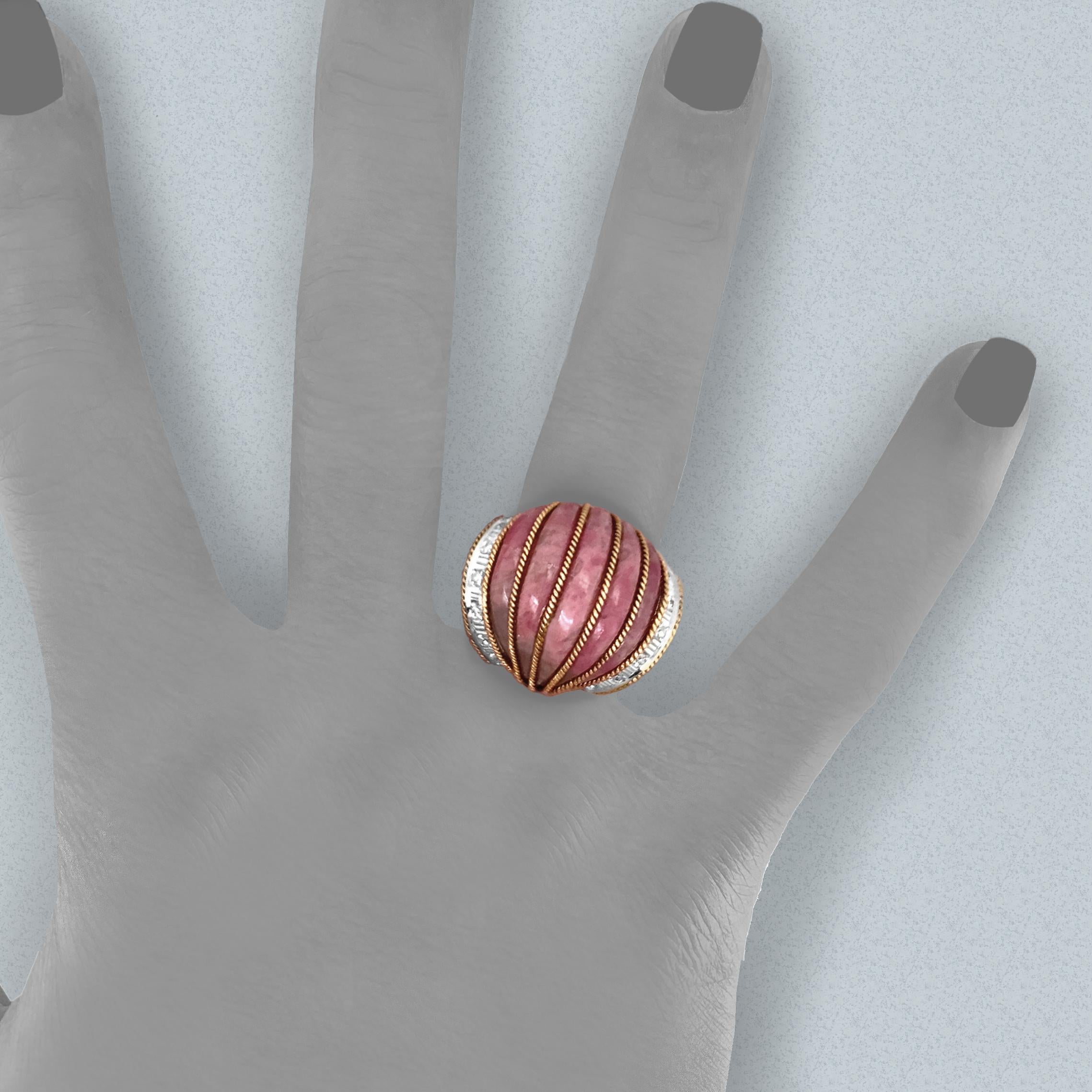 This unusual ring, undoubtedly a custom piece, features a fluted wedge of rhodochrosite.  A beautiful, rasberry-colored stone, rhodochrosite only came on the market in the 1940s with an important discovery in Argentina.  

The stone is 