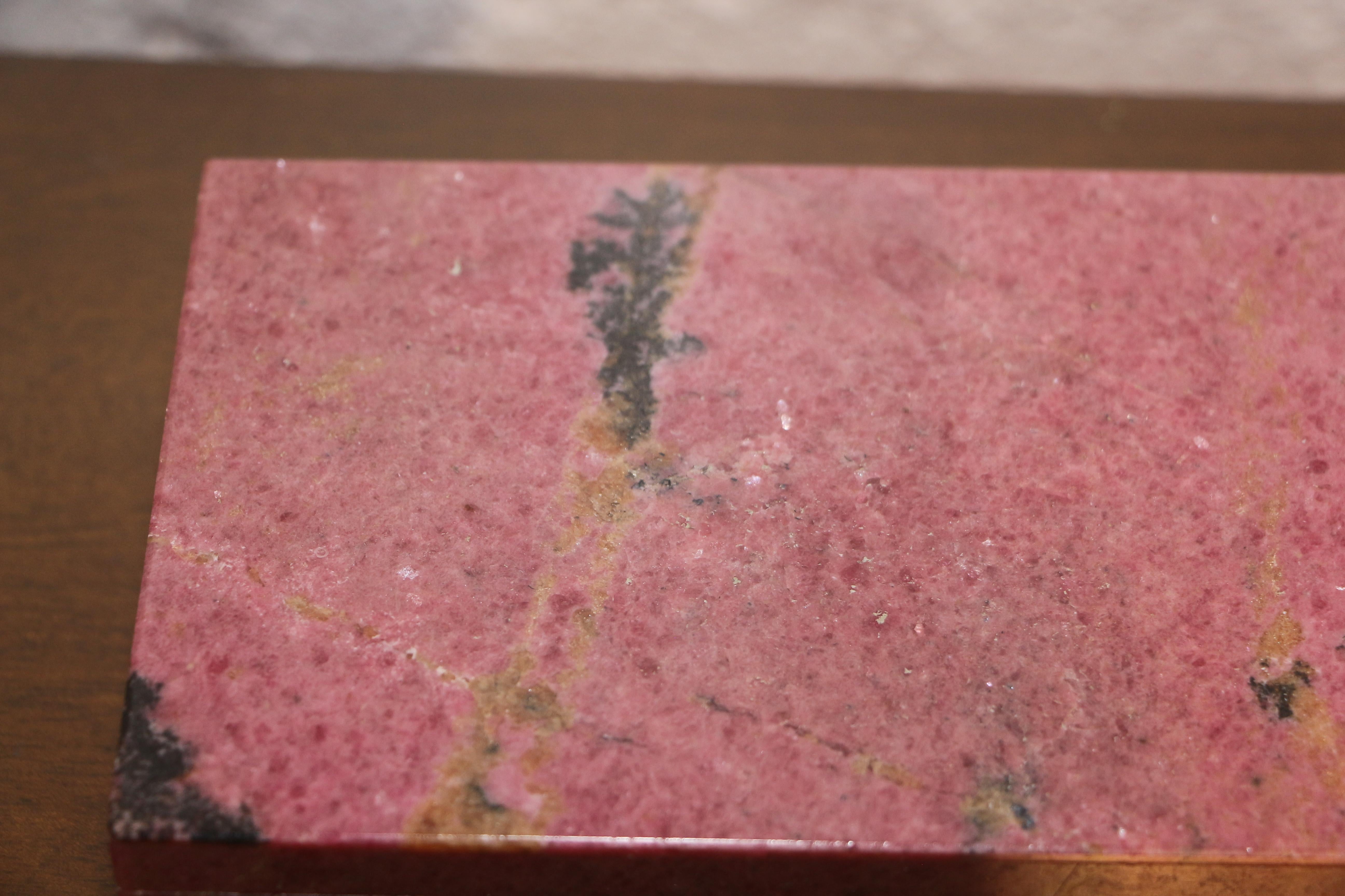 A beautiful box veneered in Rhodochrosite a somewhat rare mineral, used in many decorative forms including jewelry. This exquisite box is quite large for this mineral and measures approx 6x4 inches. it features a brass hinge and the inner box is