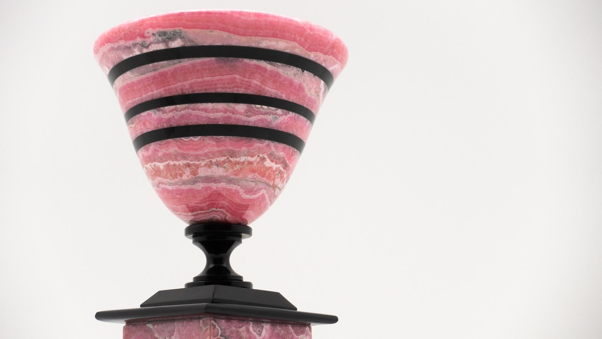 Rhodochrosite chalice with black obsidian bands on the bowl, stem, and foot. Rhodochrosite is found mostly in Argentina and is the national stone of that country. Rhodochrosite properties are know for helping in matters of love and strength... Just
