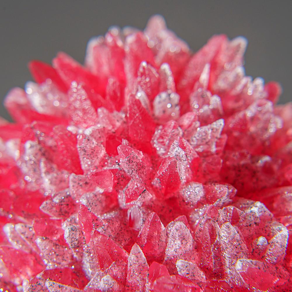 From N'Chwaning Mine, Kalahari Manganese Field, Northern Cape Province, South Africa.

Rich specimen of Transparent pink rhodochrosite crystals with sugar-like microcrystals on the surfaces of colorless quartz and black manganite. The rhodochrosite