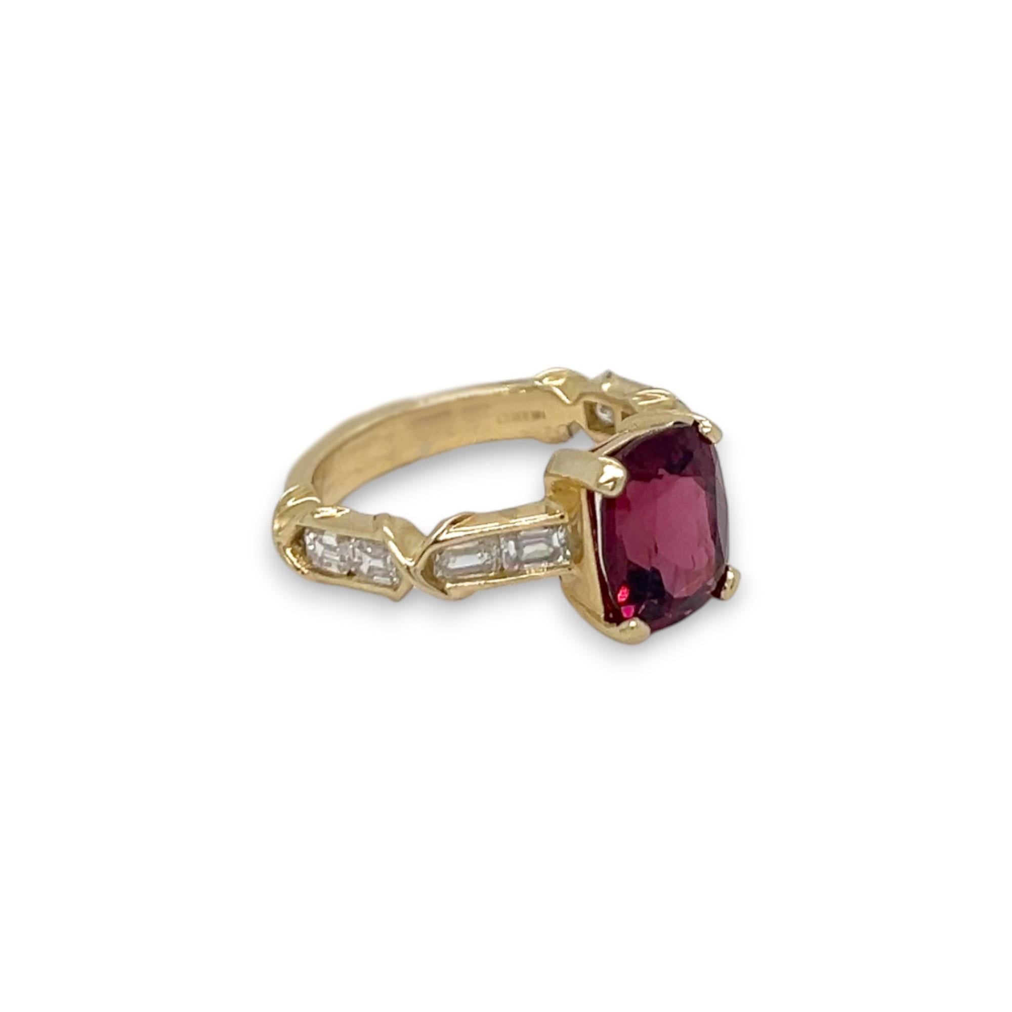 This gorgeous ring features a beautiful Rhodolite and emerald cut side diamonds set in 14k yellow gold. 

SPECIFICS:
-Cushion Cut Rhodolite Center Stone: 3.85 carat 
-Emerald Cut Diamonds: 0.93 total carat weight
-Color of Diamonds: H/I 
-Clarity of