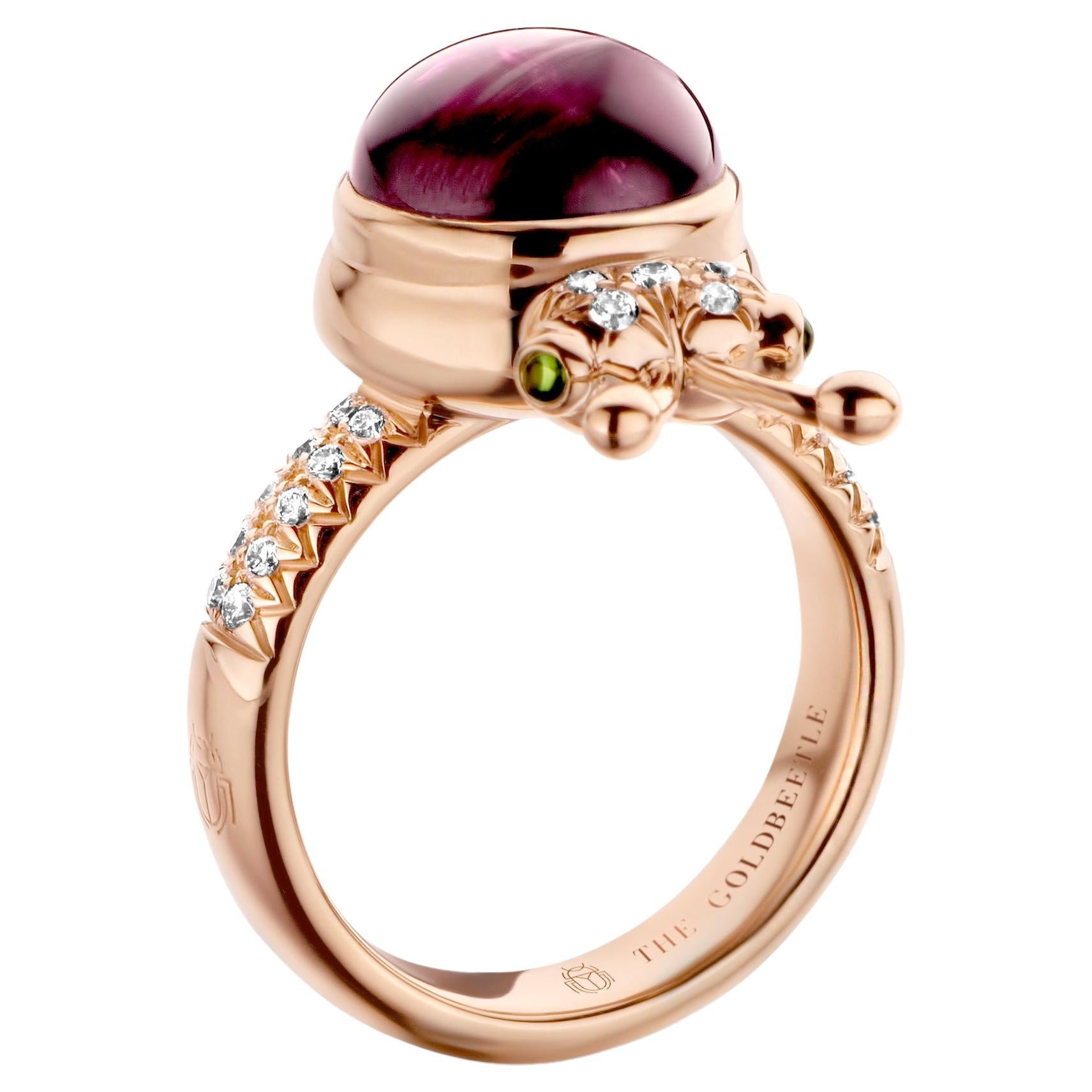 One-of-a-kind lucky beetle ring in 18 Karat rose gold 10g set with the finest natural diamonds in brilliant cut 0,23 Carat (VVS/DEF quality) one natural, rhodolite garnet in round cabochon cut 6,00 Carat and two tsavorites in round cabochon cut.