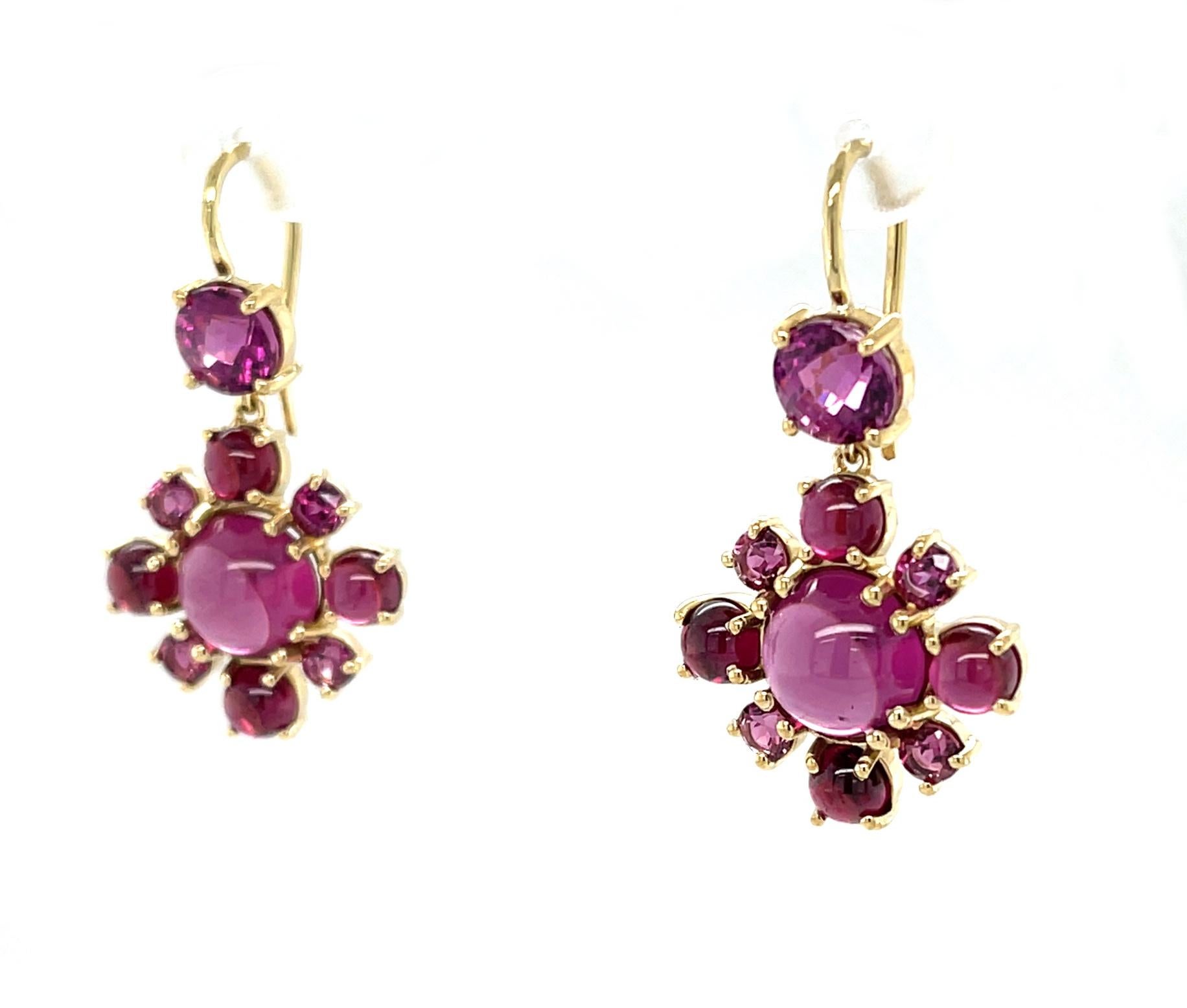 These pretty earrings are perfect for anyone who loves roses and gemstones! Beautifully custom-designed in 18k yellow gold, these original earrings feature a stunning collection of purplish-pink rhodolite garnets, whose name originates from the