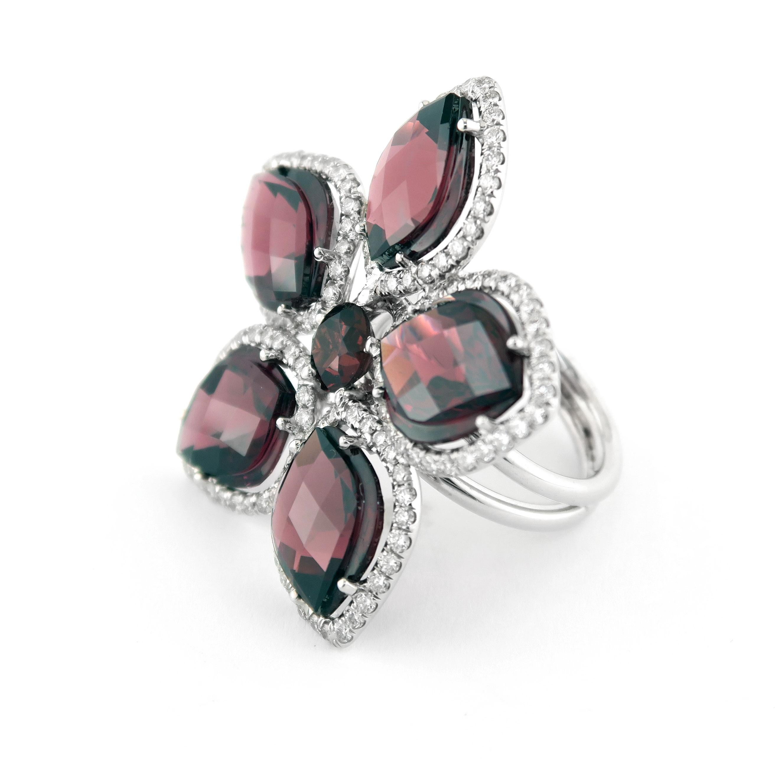 Introducing the 18 Karat White Gold and Garnet Flower Ring, a piece of jewelry that seamlessly blends ancient tradition with modern elegance. The garnet in this ring has a rich history, with the Ancient Egyptians frequently adorning themselves with