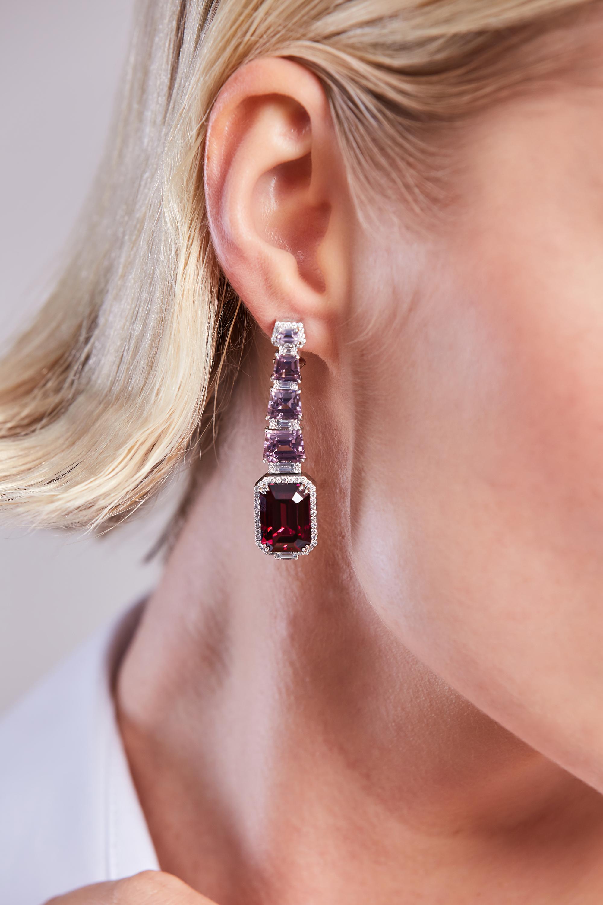 •	18k White Gold.
•	Rhodolite Garnet in emerald cut – 2 pc total carat weight 18.38.
•	Pink Spinels in fantasy cut – 8 pc total carat weight 8.02.
•	Diamonds in round & princess cut – 1.47. 
•	Product Weight – 19.61 grams.

