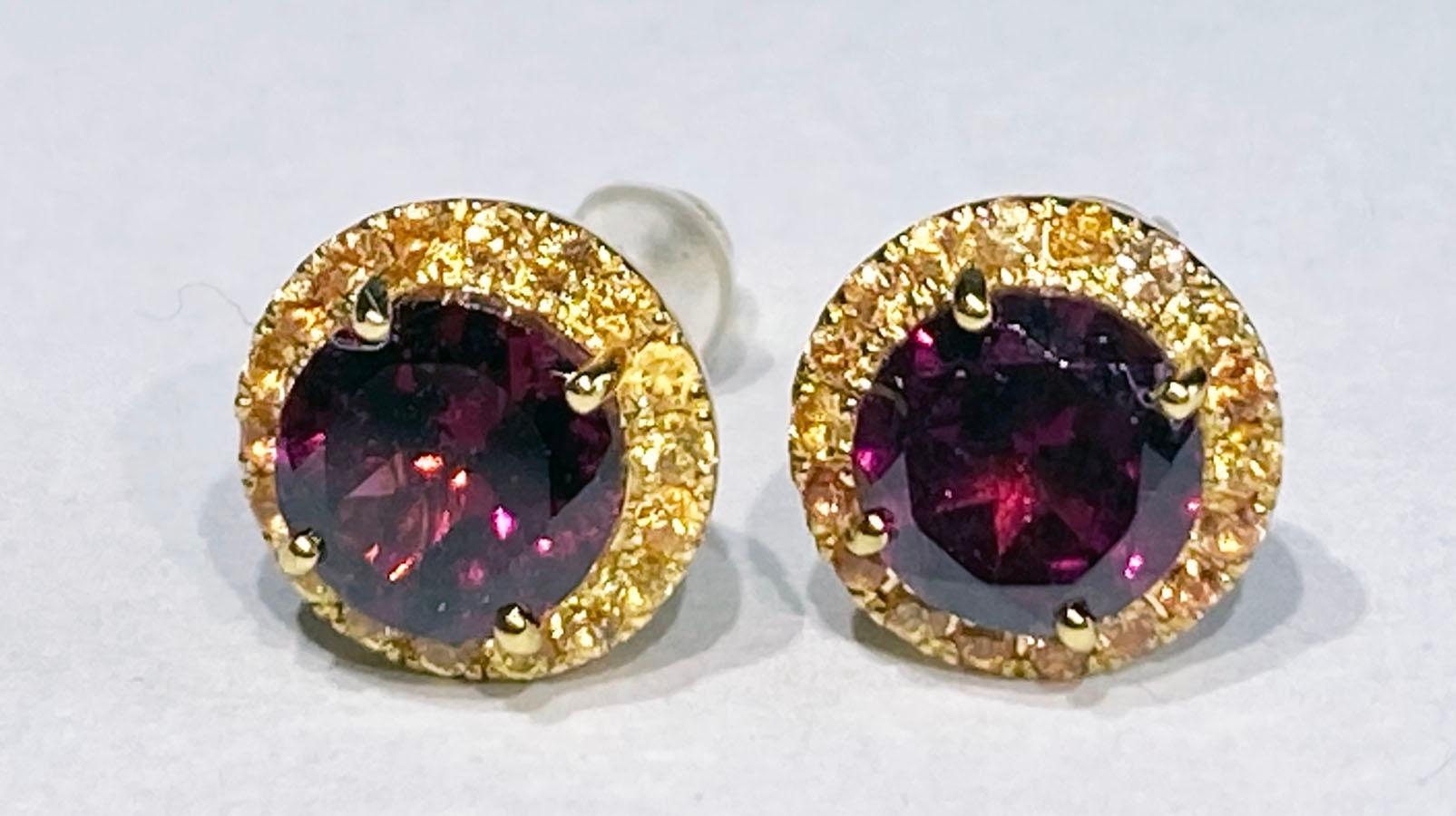 Rhodolite Garnet & Orange Sapphire Earrings set in 14kt Yellow Gold. Rhodolite Garnets are 1.83 Carats total weight with 0.3 Carats of round Yellow Sapphires surrounding the Garnets.

Originally from San Diego, California, Kary Adam lived in the