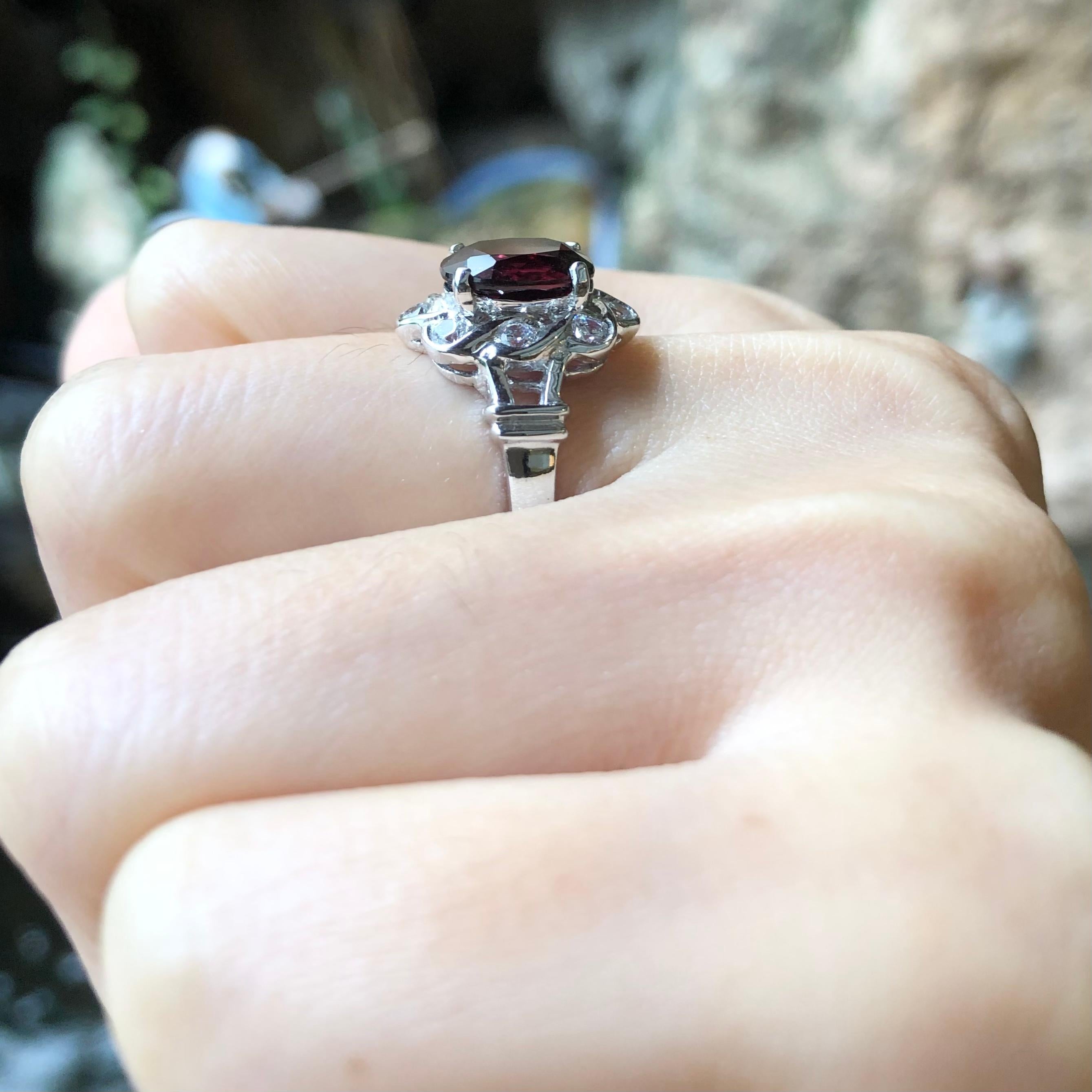 Rhodolite with Cubic Zirconia Ring set in Silver Settings

Width:  1.1 cm 
Length: 1.5 cm
Ring Size: 50
Total Weight: 4.04 grams

*Please note that the silver setting is plated with rhodium to promote shine and help prevent oxidation.  However, with