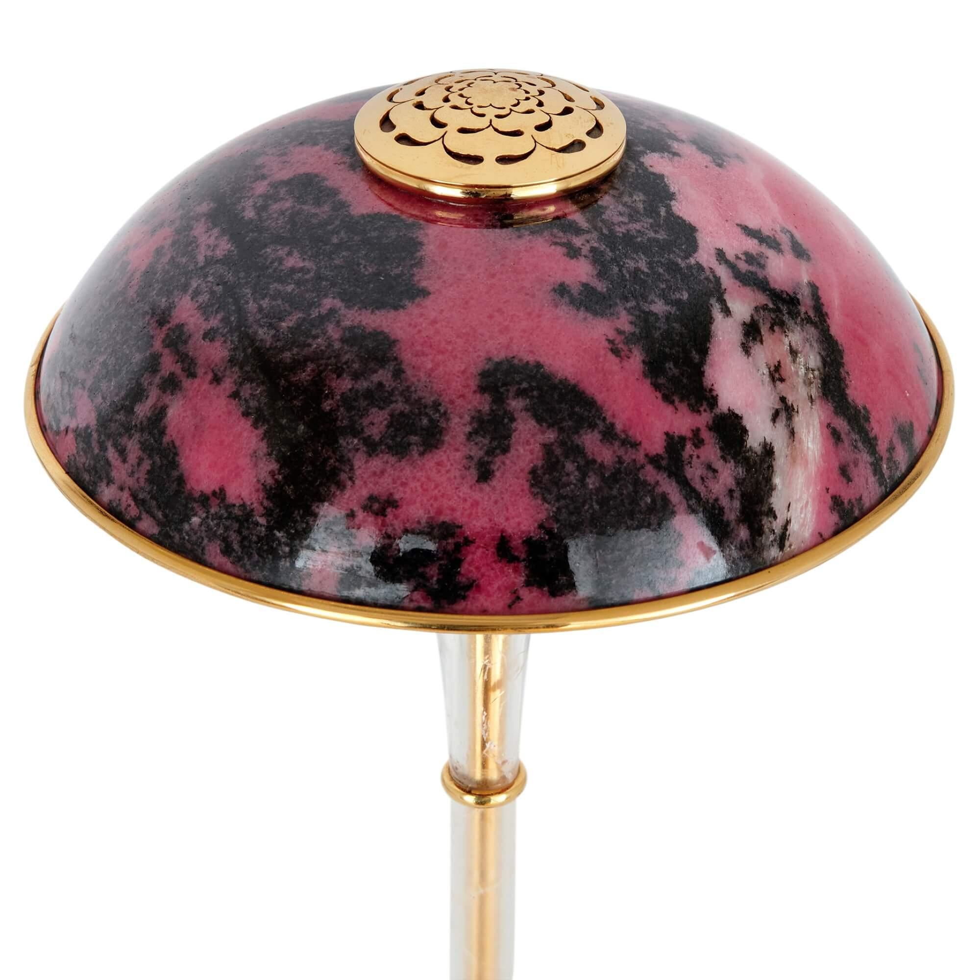 Rhodonite, rock crystal and vermeil desk lamp by Asprey 
English, circa 1970 
Height 61cm, diameter 22cm

This spectacular desk lamp is crafted from an array of rare and luxurious materials. 

Rhodonite, the stone symbolising compassion, is