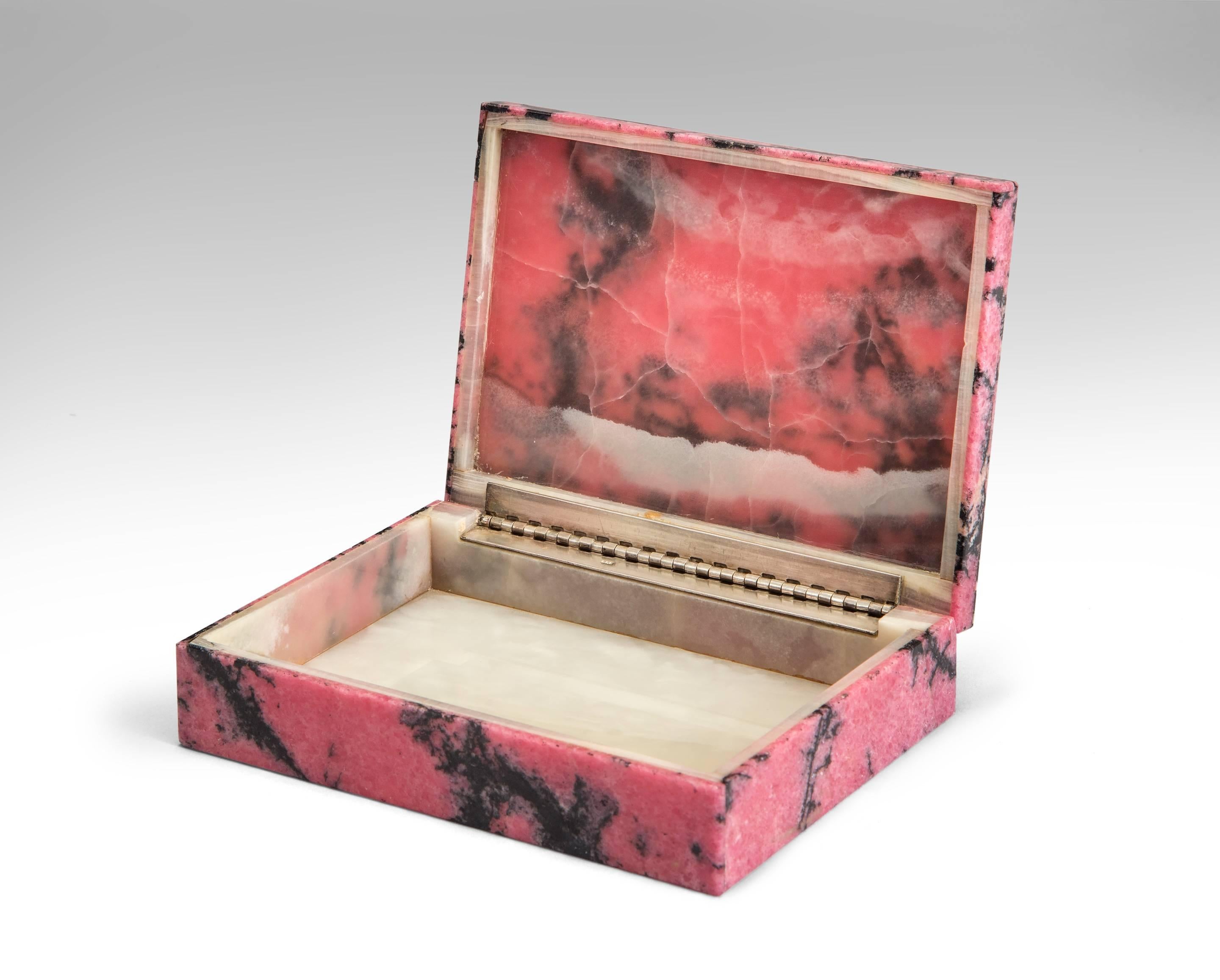 Rhodonite, onyx and silver box
20th century.
A semiprecious favourite stone of the Russian Czars, this rhodonite box is not only crafted with exceptional skill but is composed of the most desired dark colored rhodonite. The rectangular box of dark