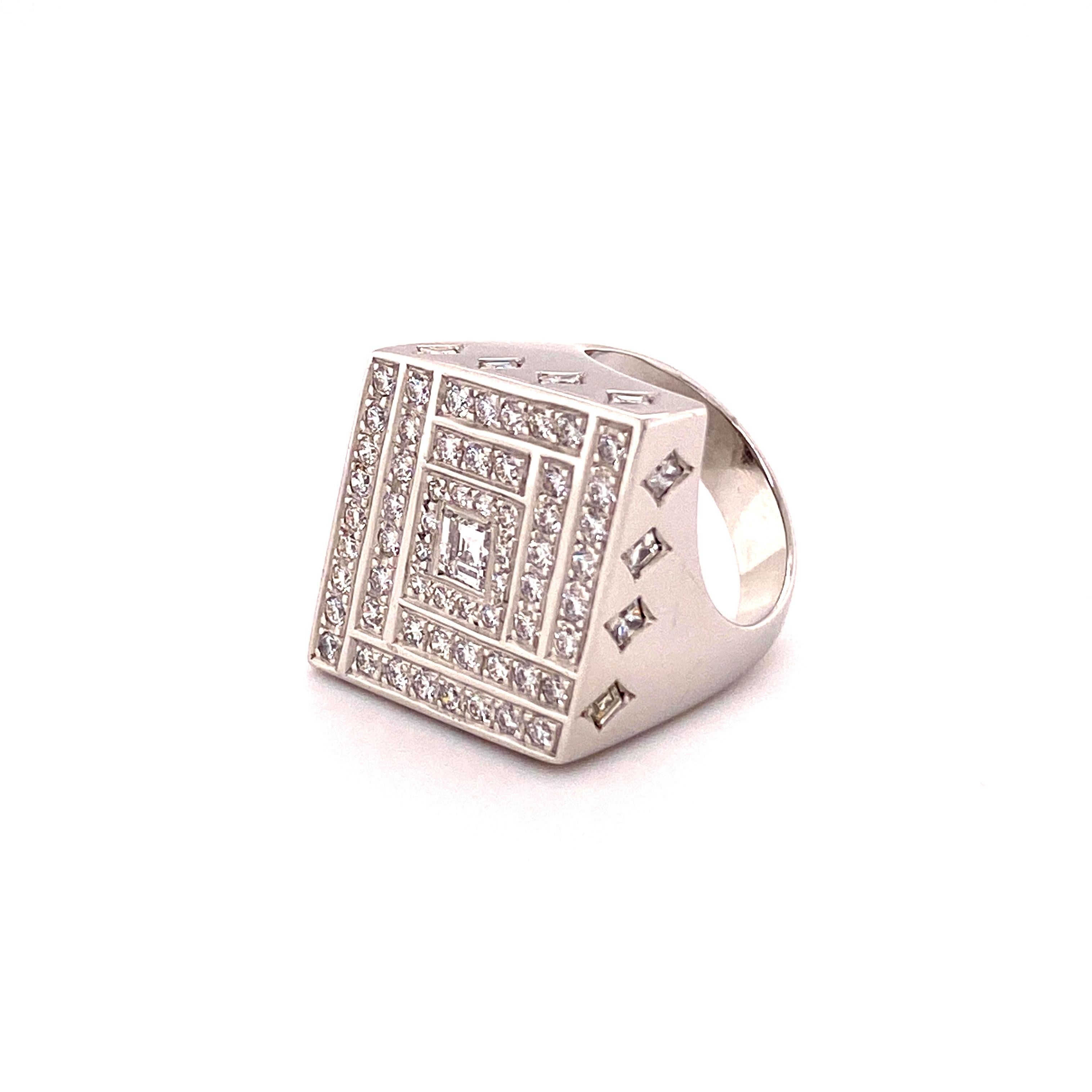 This ring captivates by its clear geometrical design. The slightly thicker white gold bars between the diamonds create a great light effect. 60 pavé-set brilliant-cut diamonds surround a carré cut diamond in the center. At the side, the rhombic