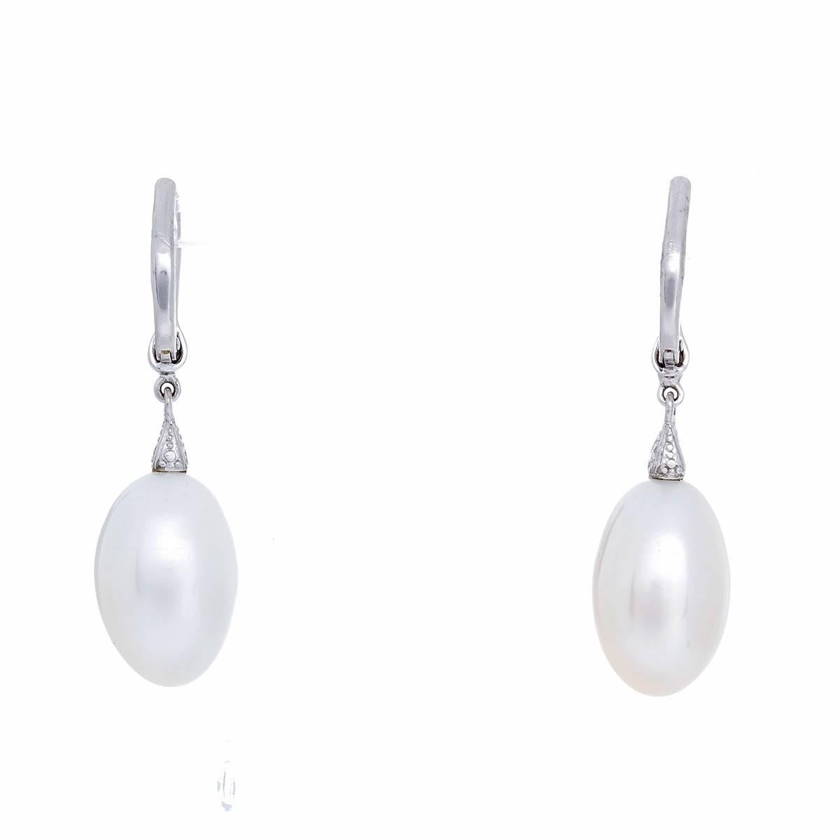 These Rhonda Faber Green earrings feature  0.47 ctw. of full-cut diamonds (Color: G-H-I, Clarity: VS) with a baroque freshwater cultured pearl set in 18k white gold. Pearls measure apx. 16.00 x 10.40mm and 16.00 x 10.85 mm. Earrings measure apx.