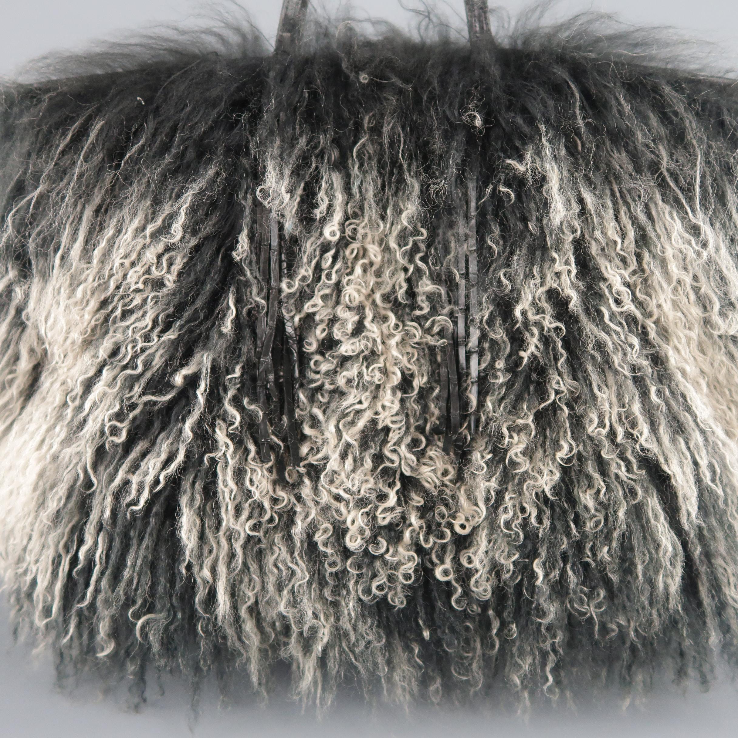 RHONDA OCHS tote bag comes in black to beige ombre Mongolian lamb fur with black alligator handles, fringe, and piping, and suede interior with magnetic closure. Bag appears much larger than measurements taken without length of fur.
 
Very Good