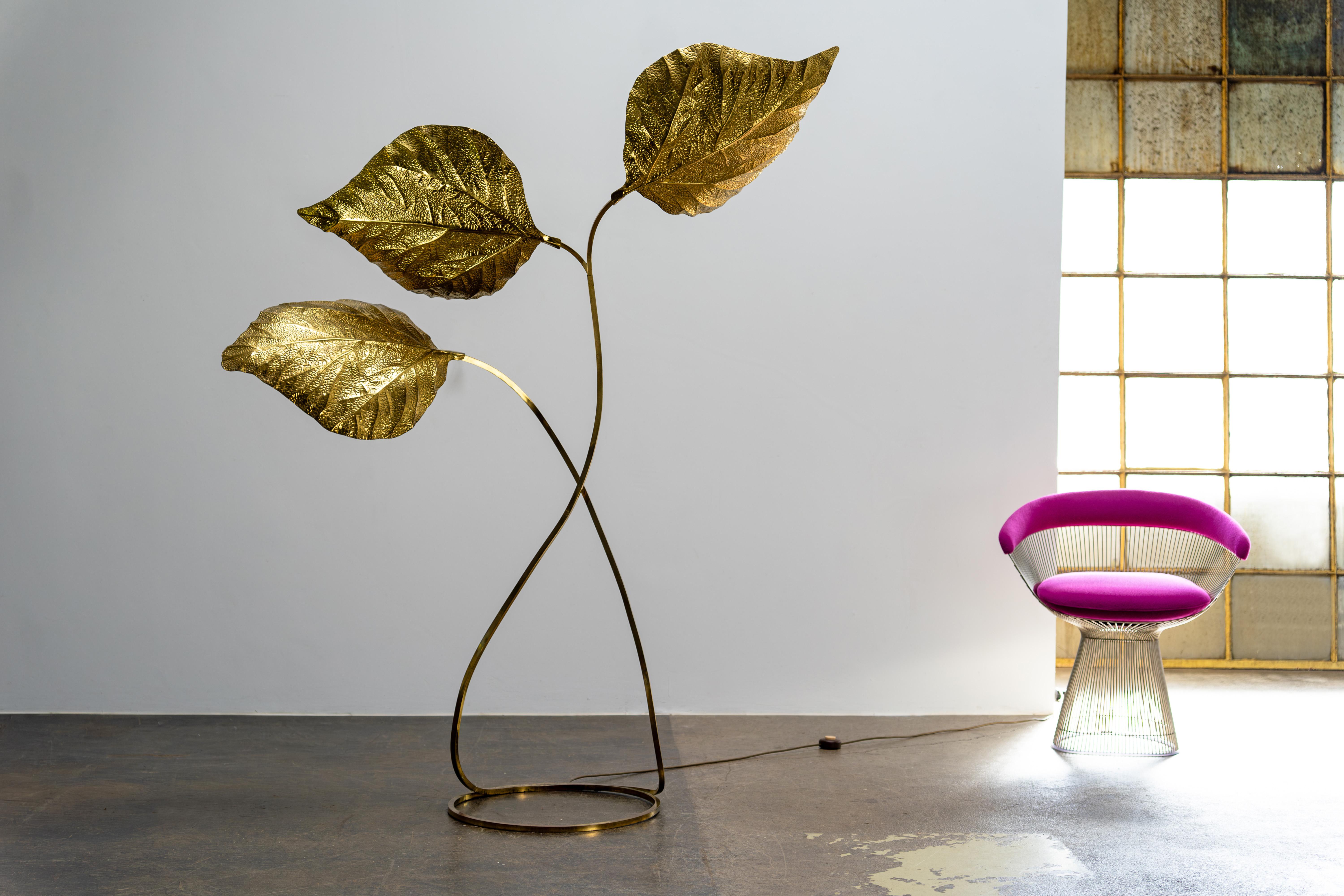 This impressive large floor lamp with three enormous leaves was designed by Tommaso Barbi and Carlo Giorgi and manufactured by Bottega Gadda in Italy during the 1970s. The sturdy brass frame extends majestically from the base, supporting three